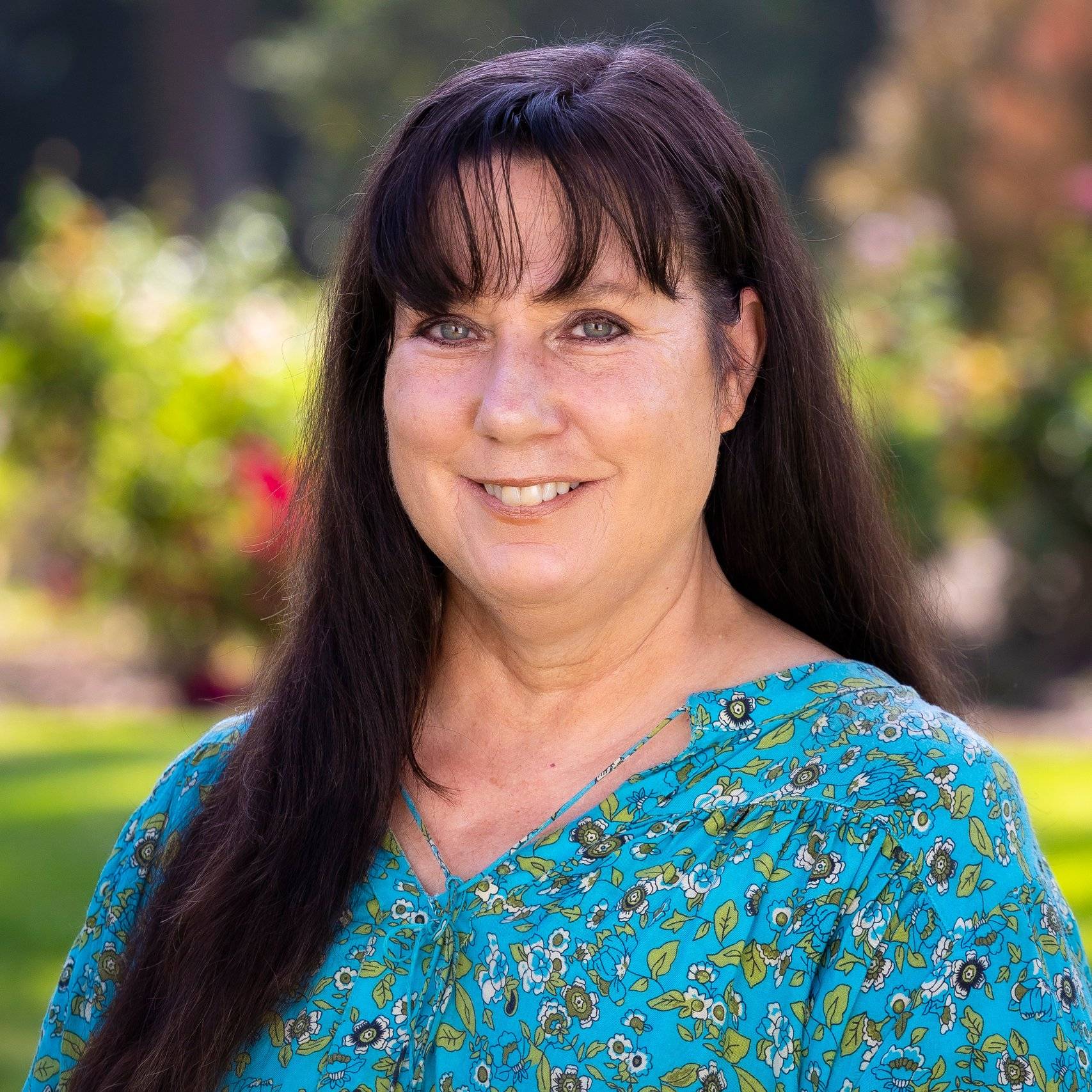 a person with long hair wearing a blue shirt