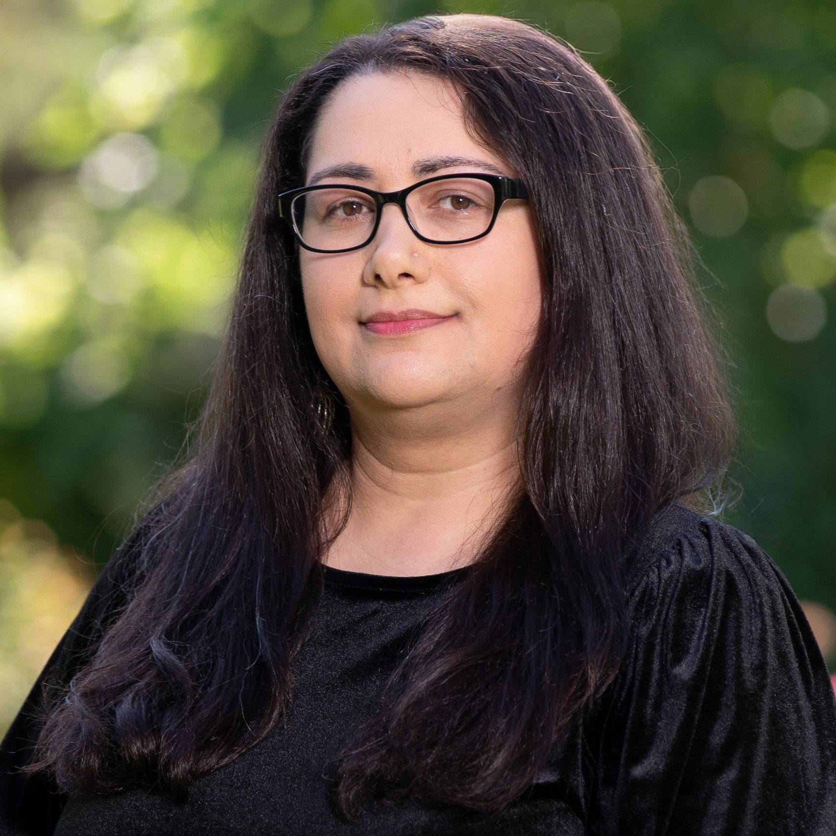 a person with long hair wearing glasses