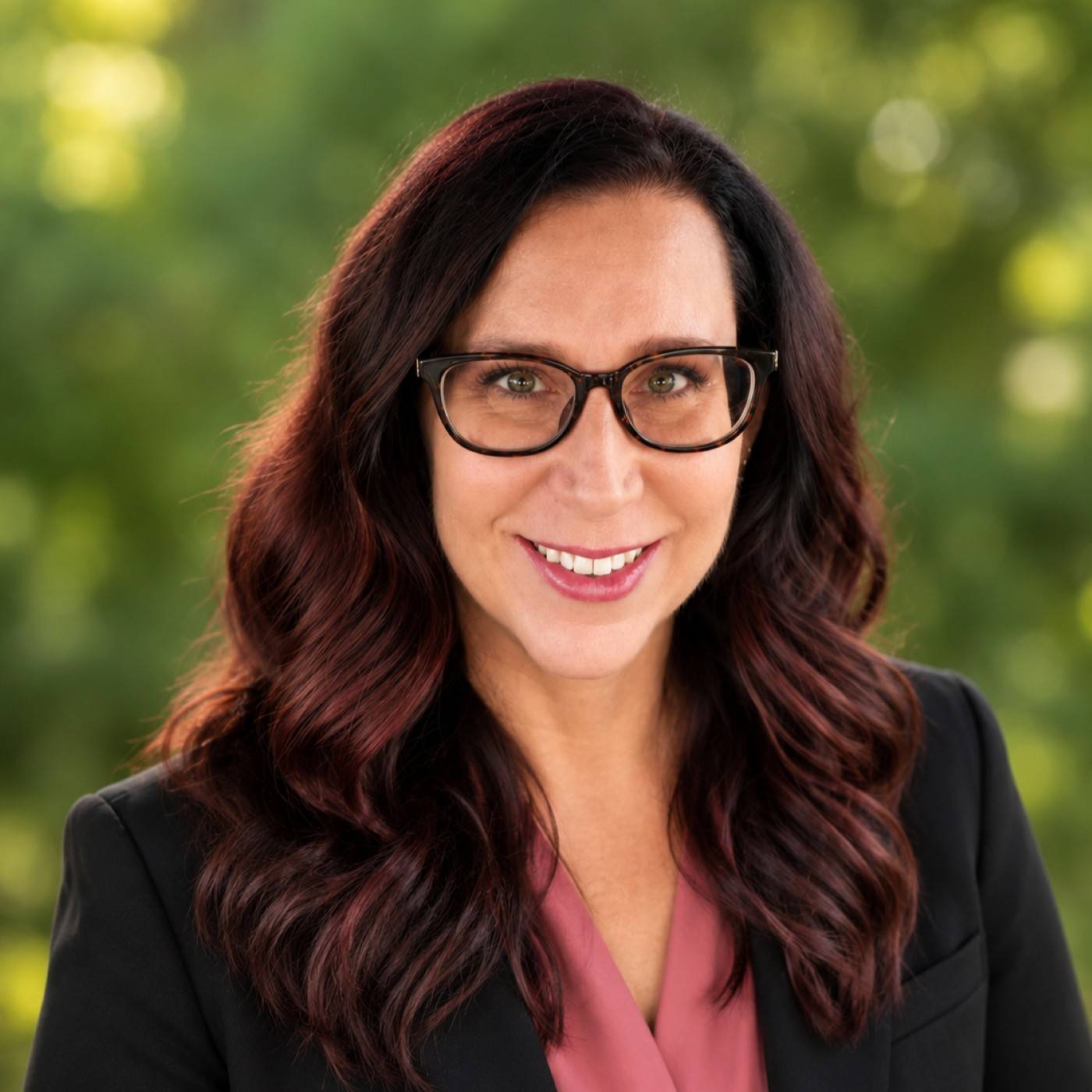 a person wearing glasses and a suit
