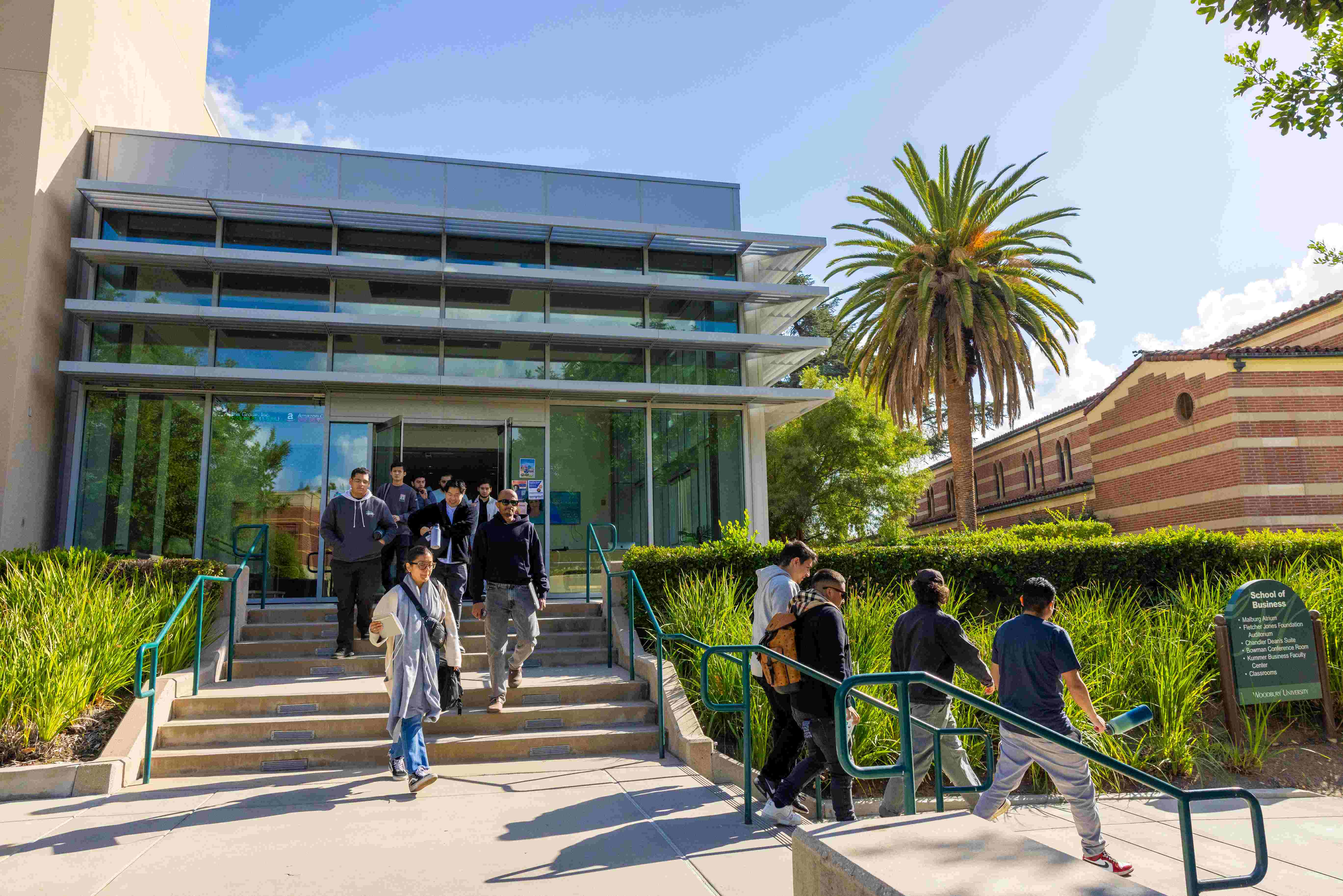 a group of people walking up stairs outside a building