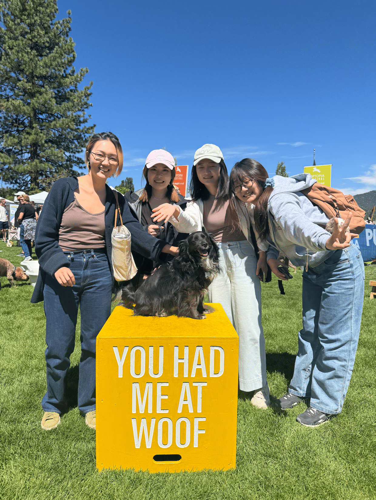 a group of women posing with a dog