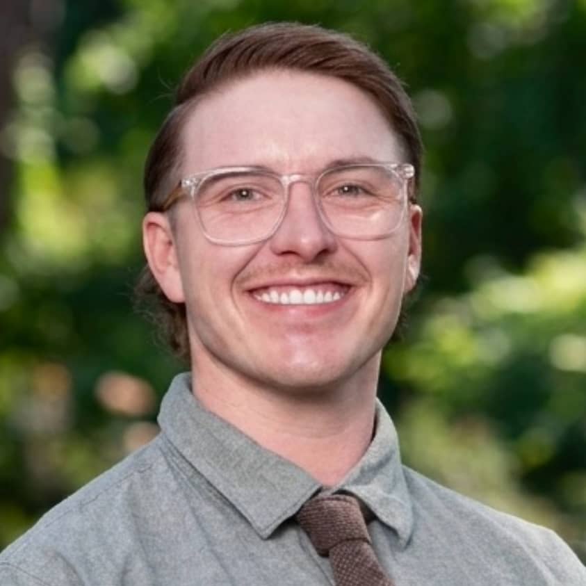 a person wearing glasses and a tie