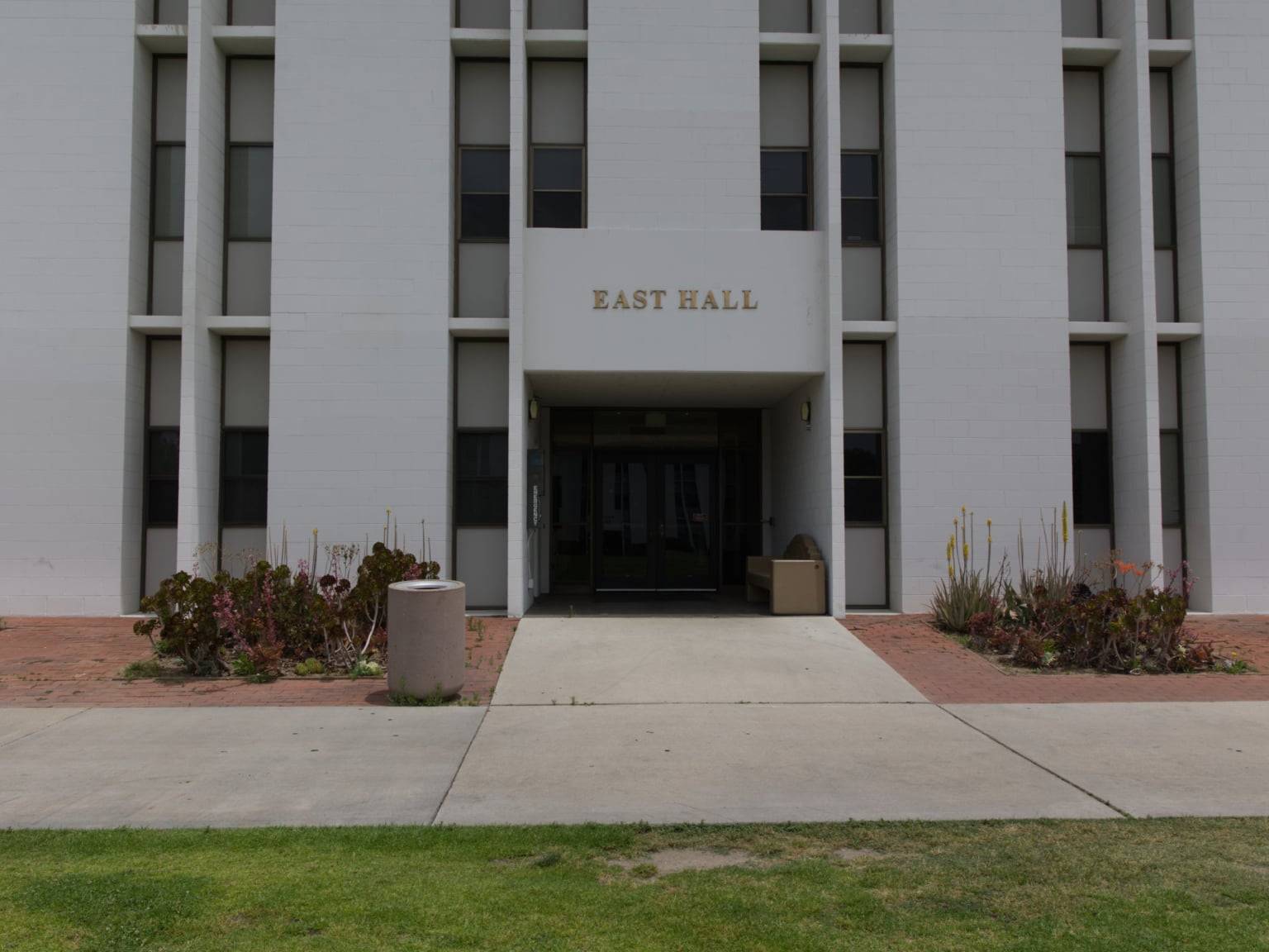 a building with a door and a lawn