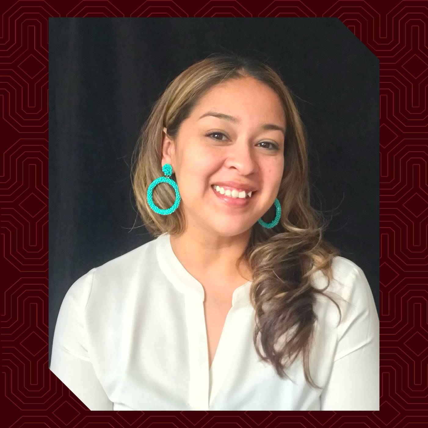 a person smiling with large earrings