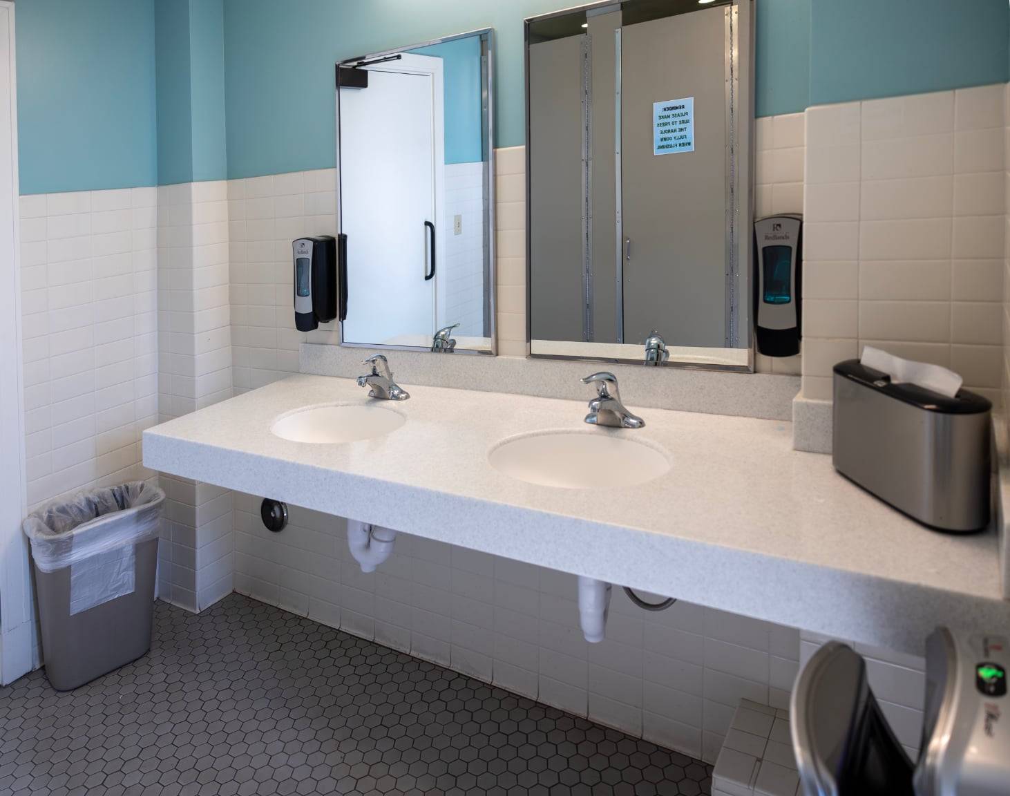 a bathroom with two sinks and mirrors