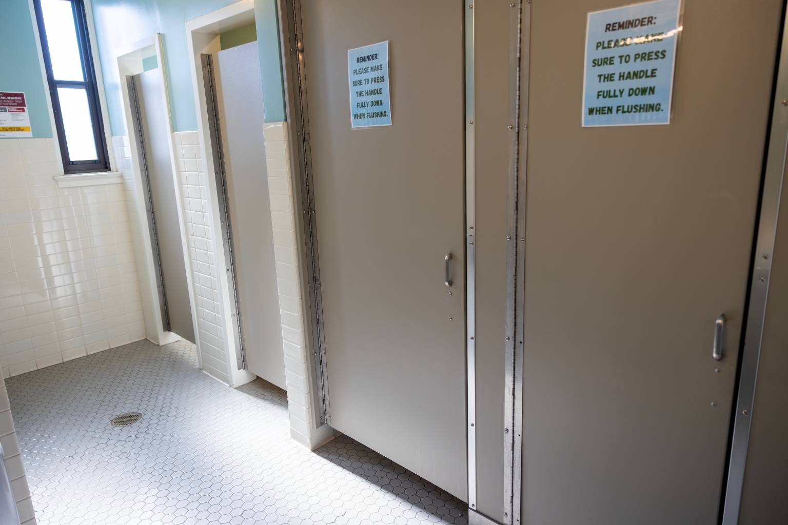 a bathroom with doors and signs