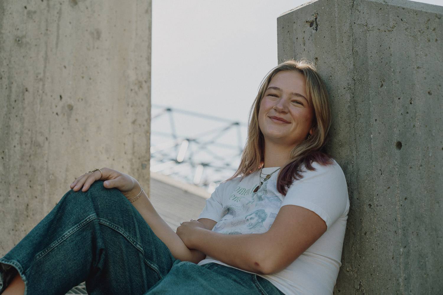a person sitting on a concrete pillar