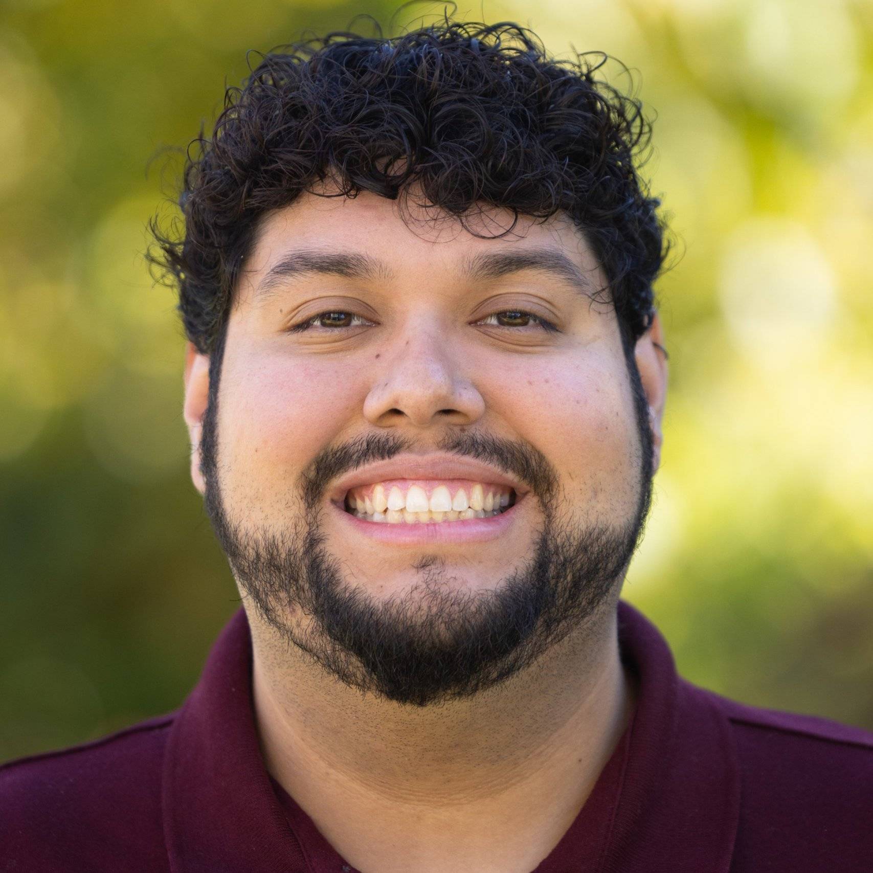 a person with a beard smiling