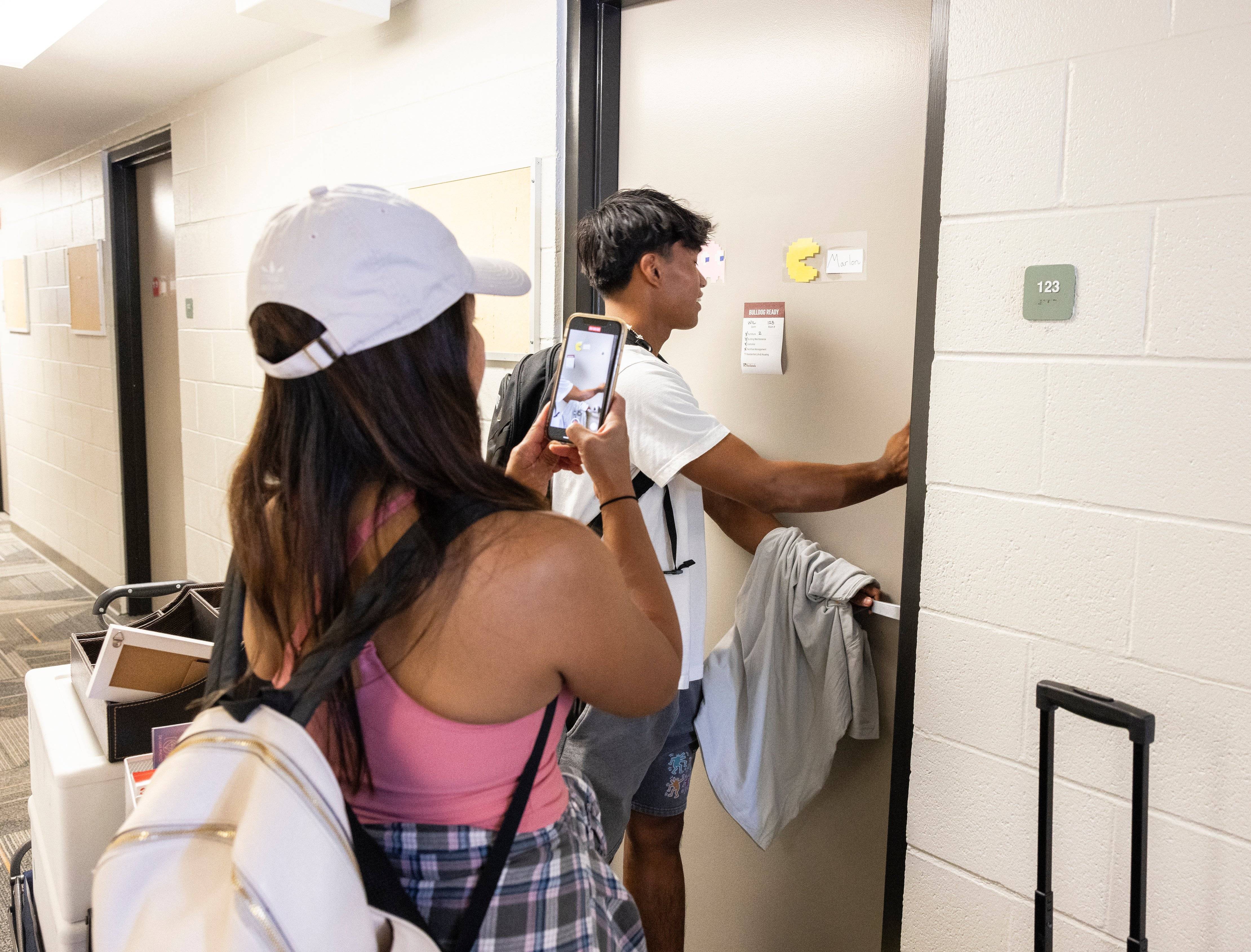 a person and person taking a picture of themselves in a mirror