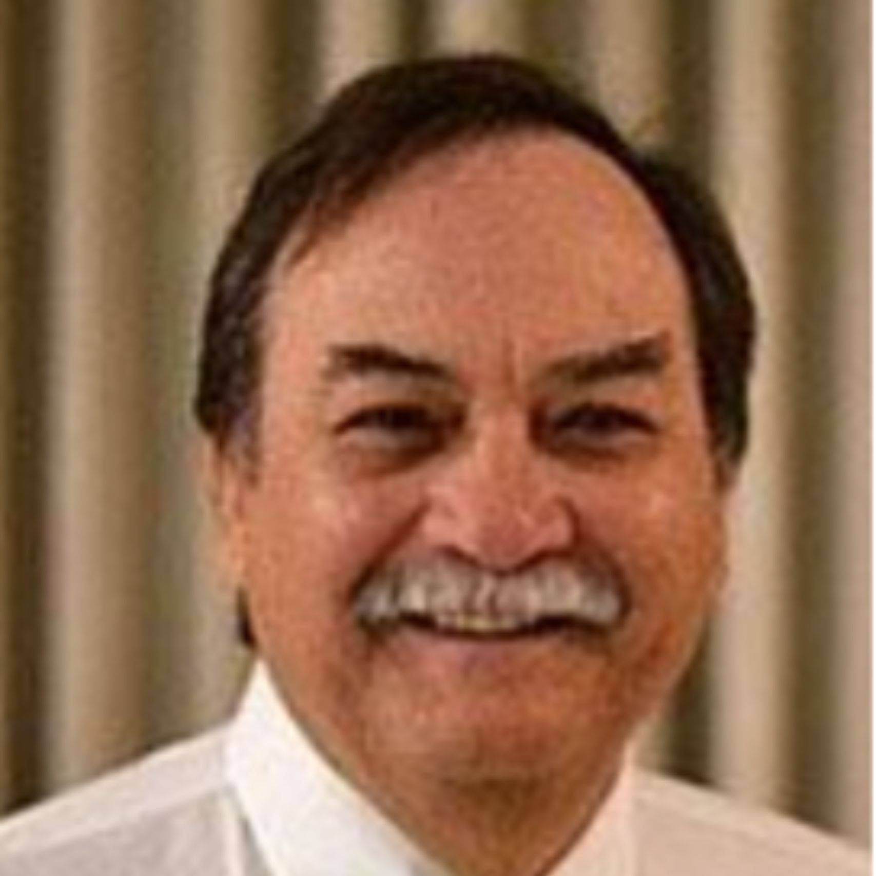 a person with a mustache smiling