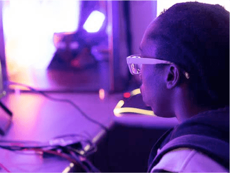 a person wearing glasses looking at a computer