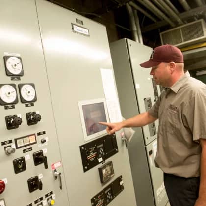 a person pointing at a machine