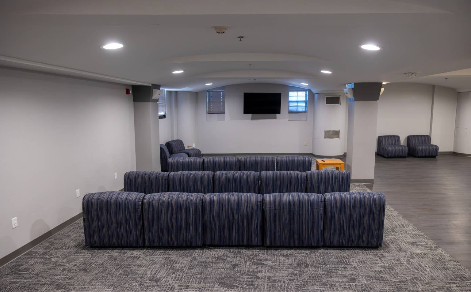 a room with blue and white striped couches