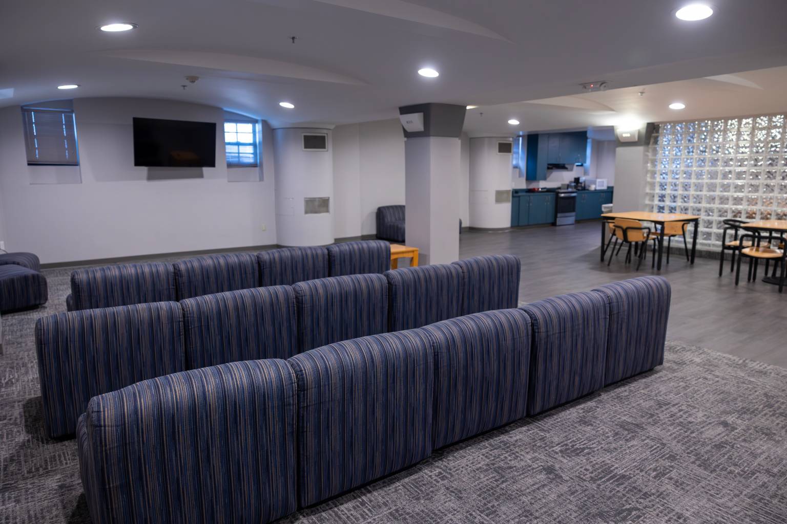 a room with blue chairs and a table
