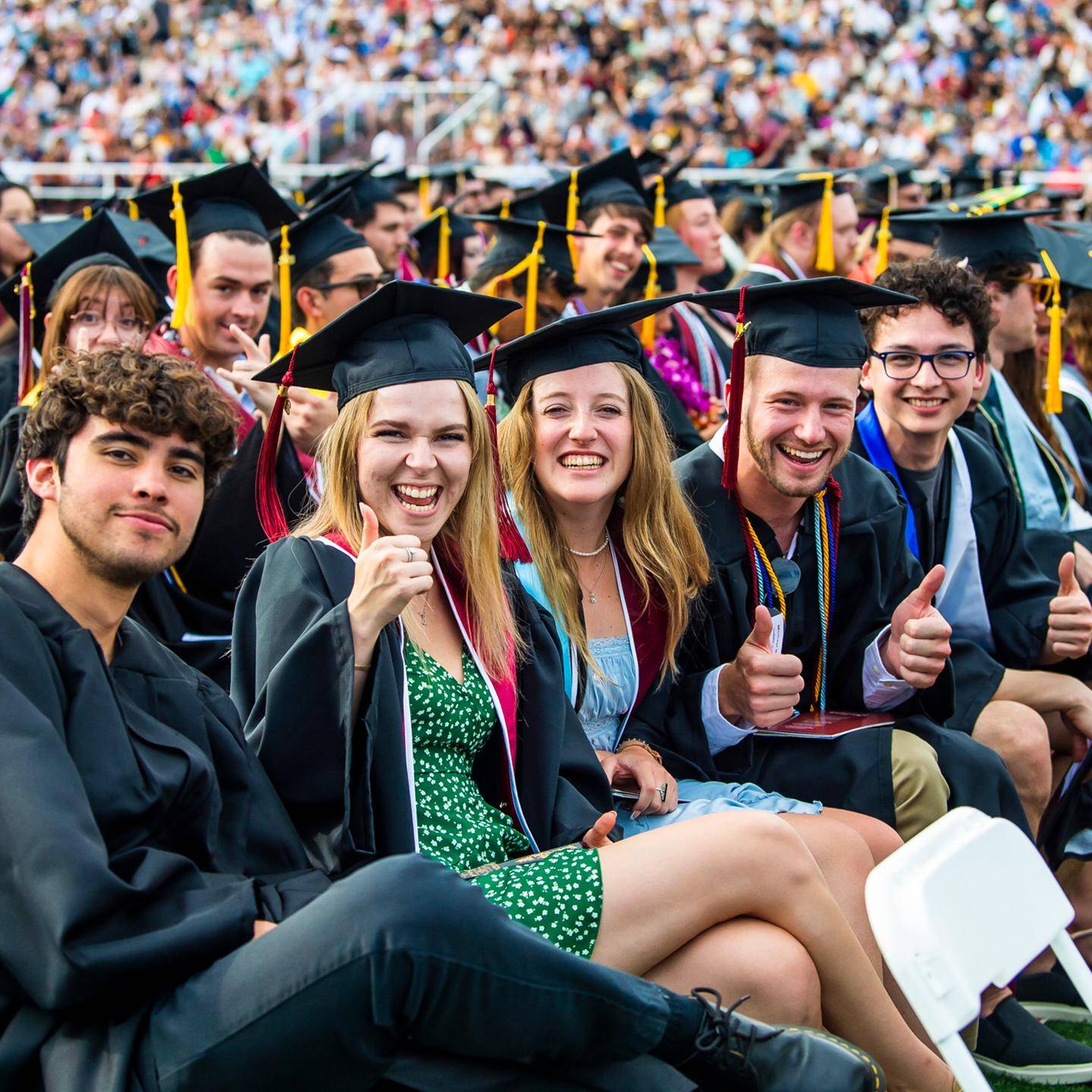 a group of people in graduation gowns and caps