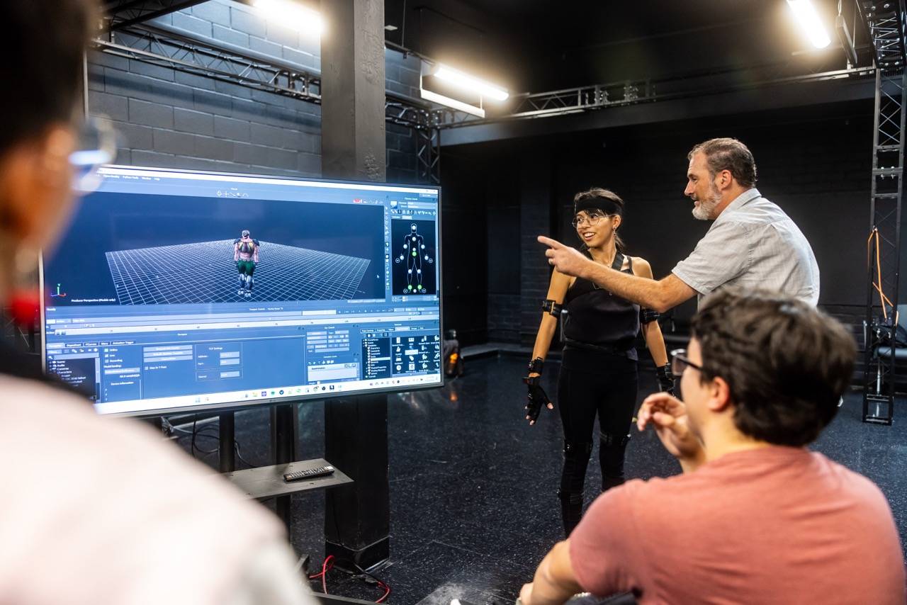 a group of people looking at a screen