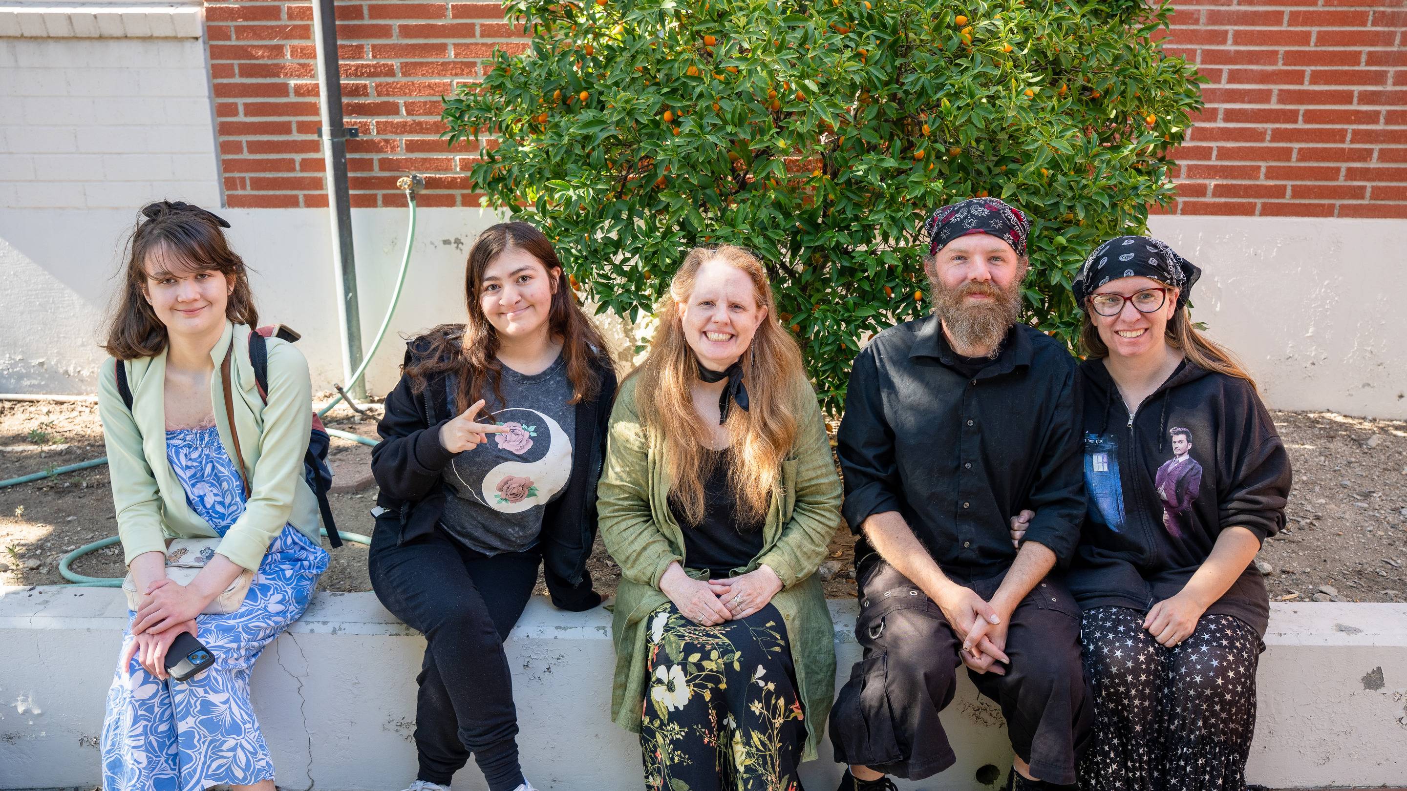 a group of people sitting on a ledge