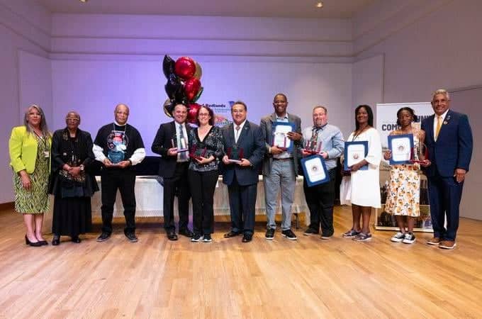 a group of people holding awards