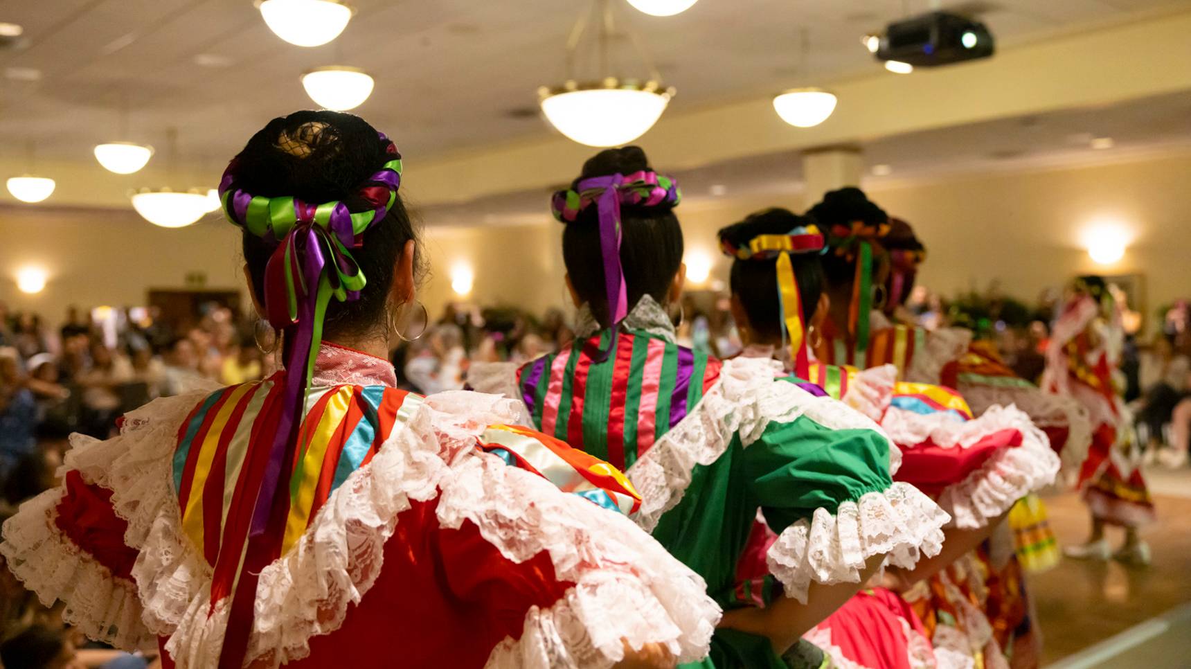 a group of women wearing colorful dresses