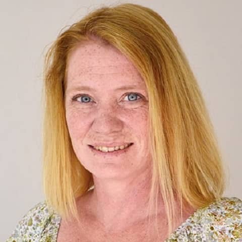 a person with blonde hair and blue eyes