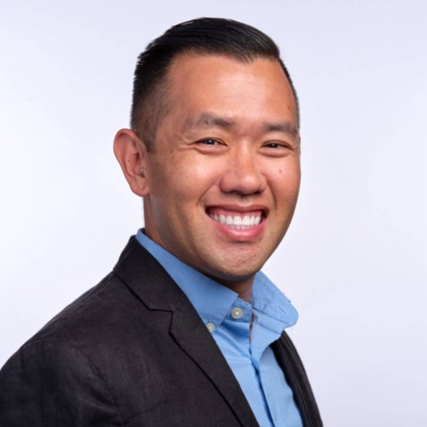 a person in a suit smiling