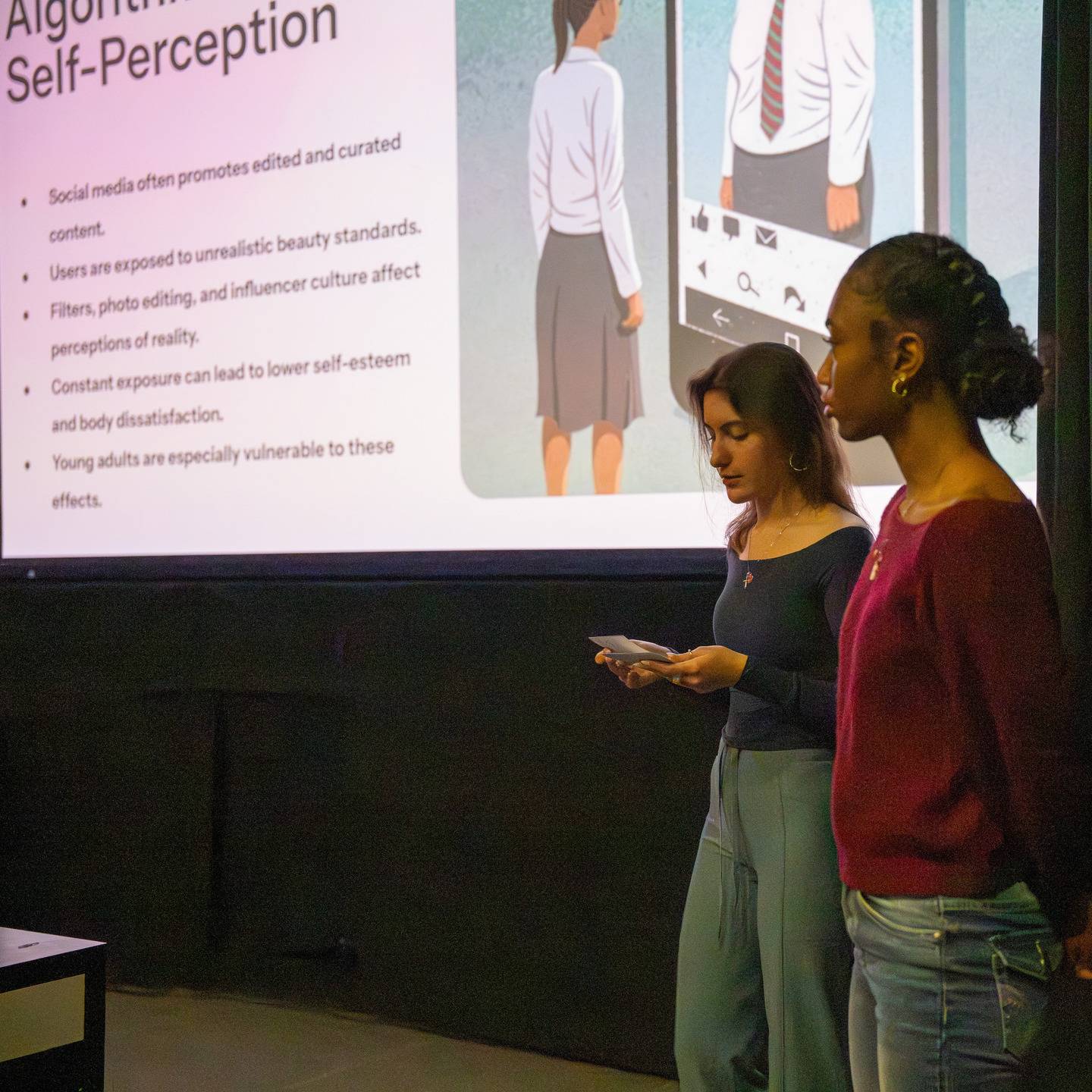 a group of women looking at a screen