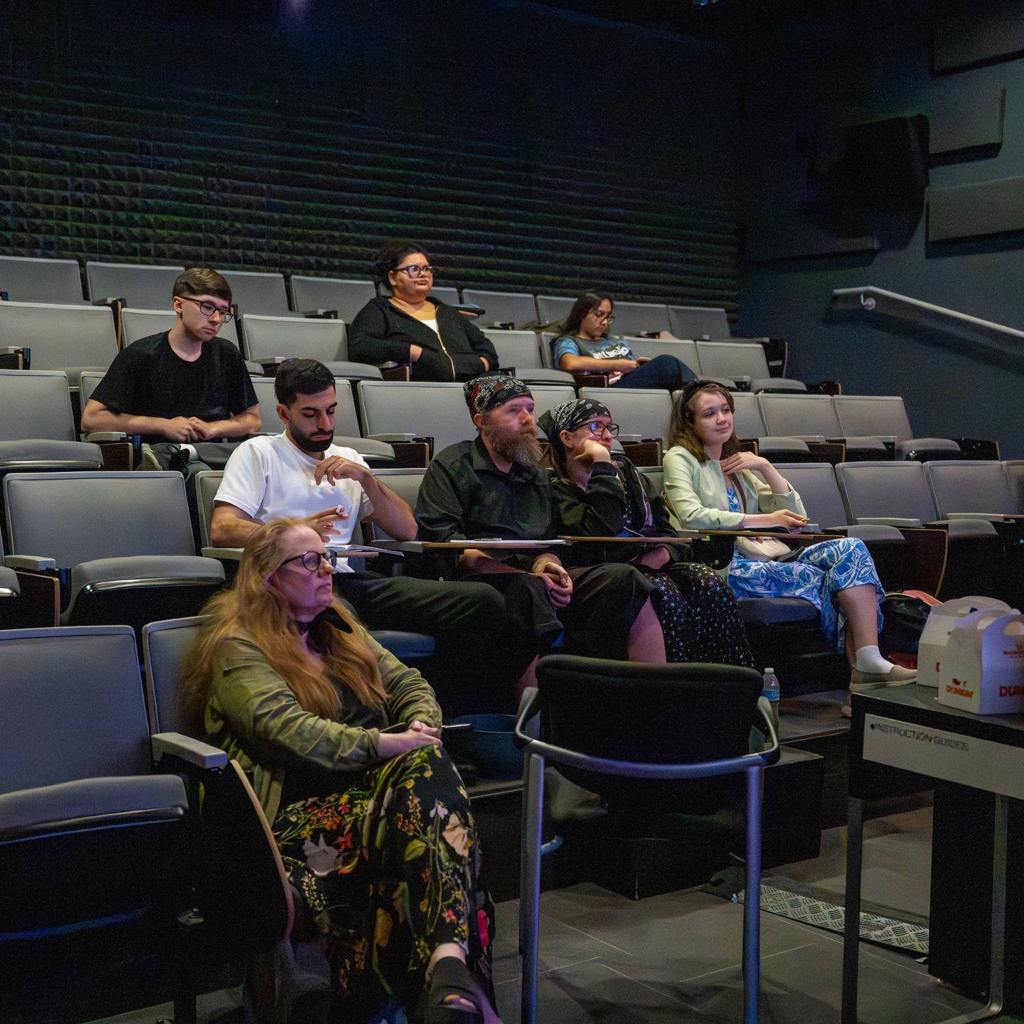 a group of people sitting in an auditorium