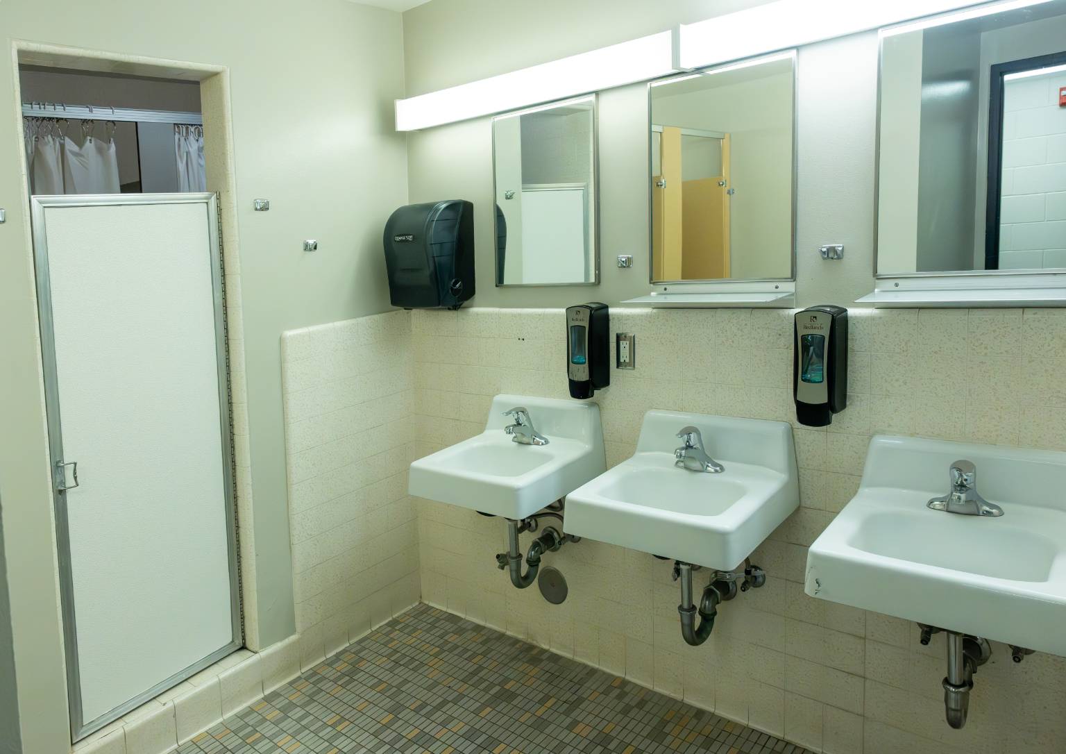 a bathroom with sinks and mirrors
