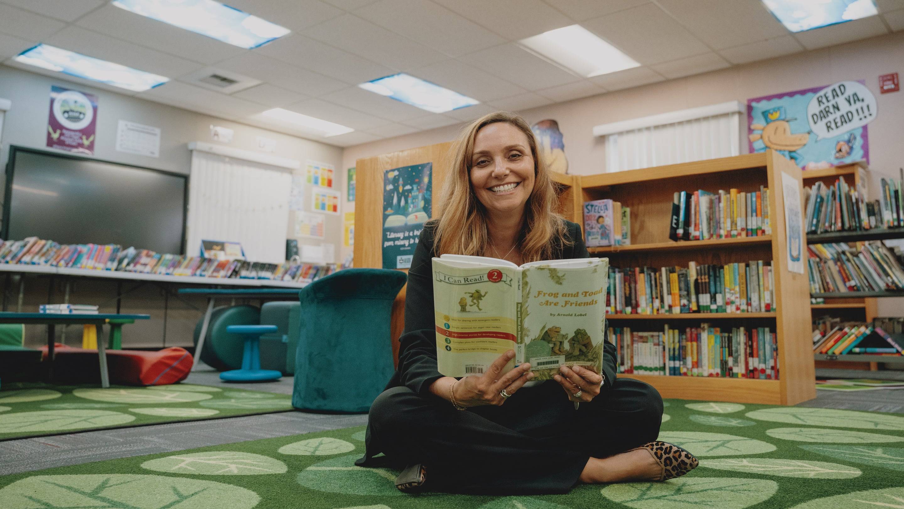 a person sitting on the floor reading a book