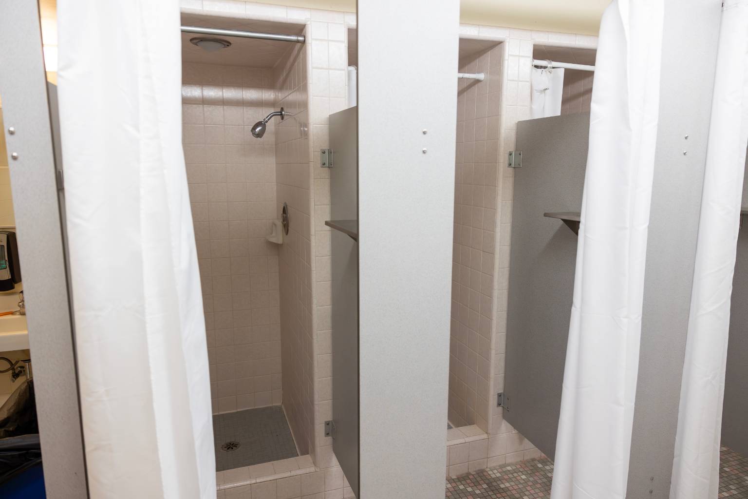a shower stall with shower curtain