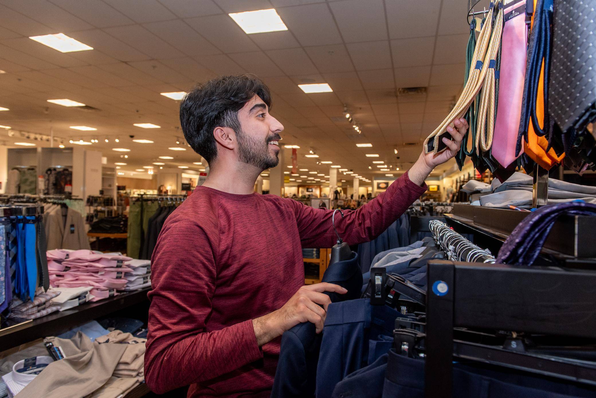 a person looking at a swinger with a variety of clothes on it