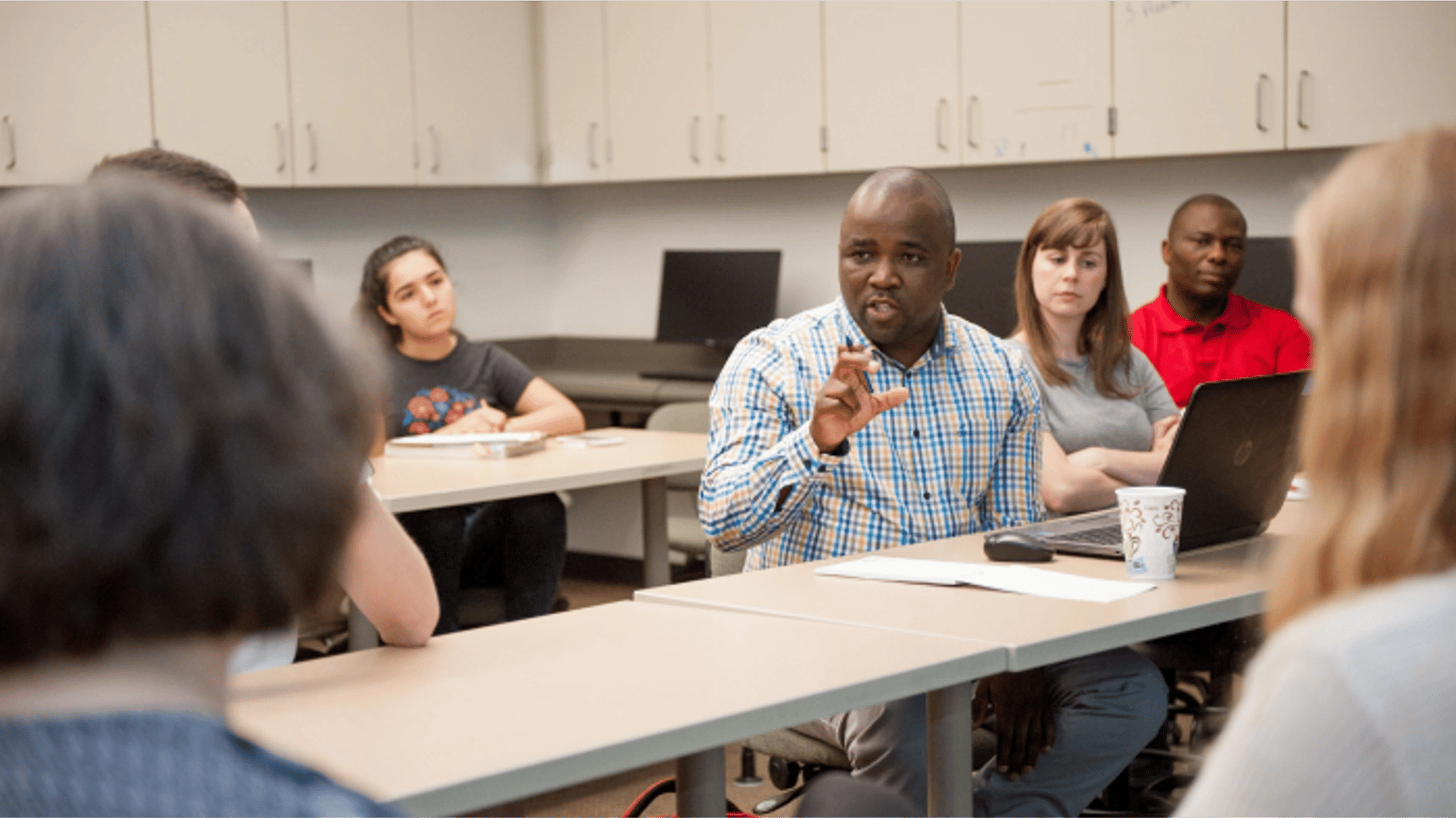 a person speaking to a group of people