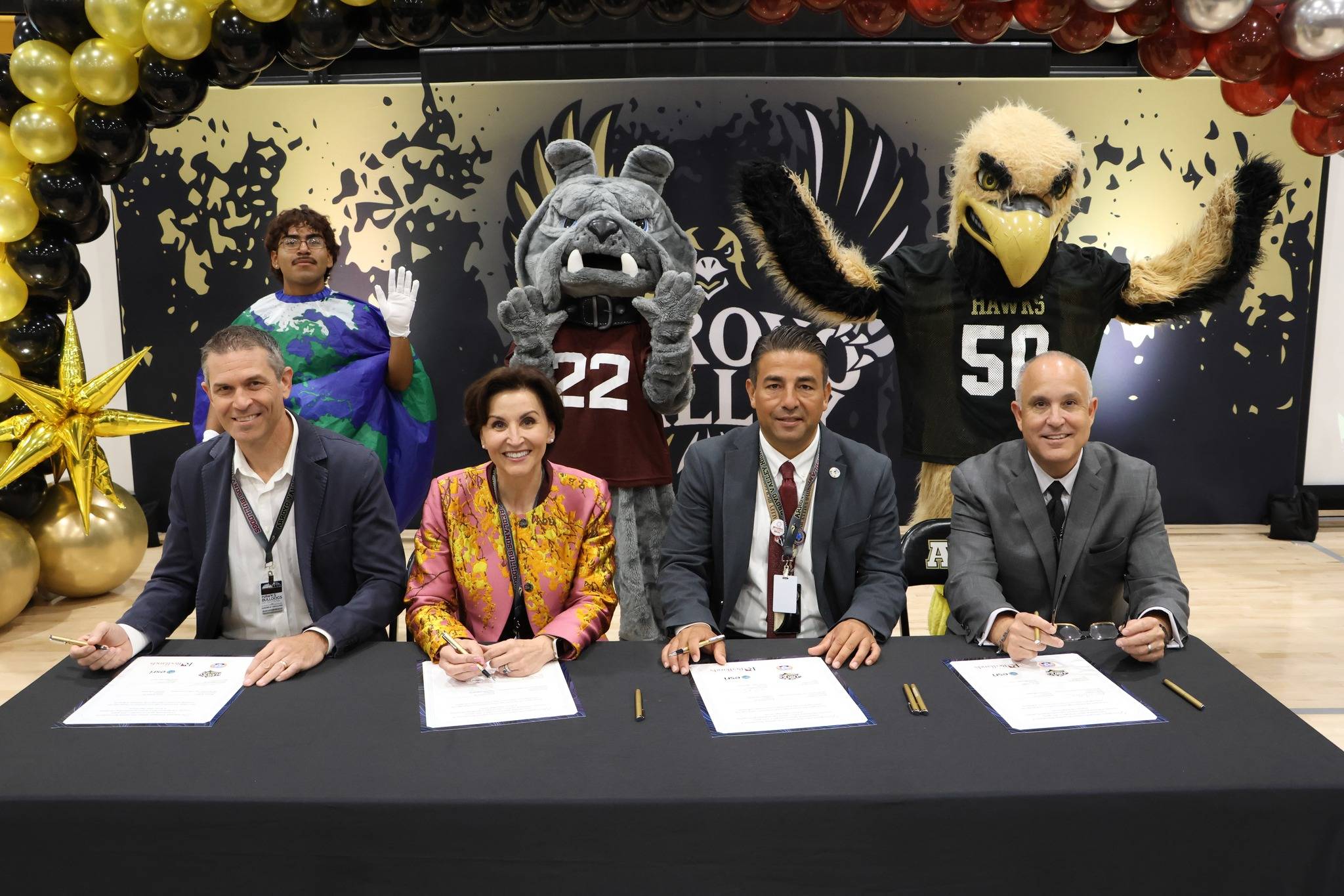 a group of people sitting at a table with papers