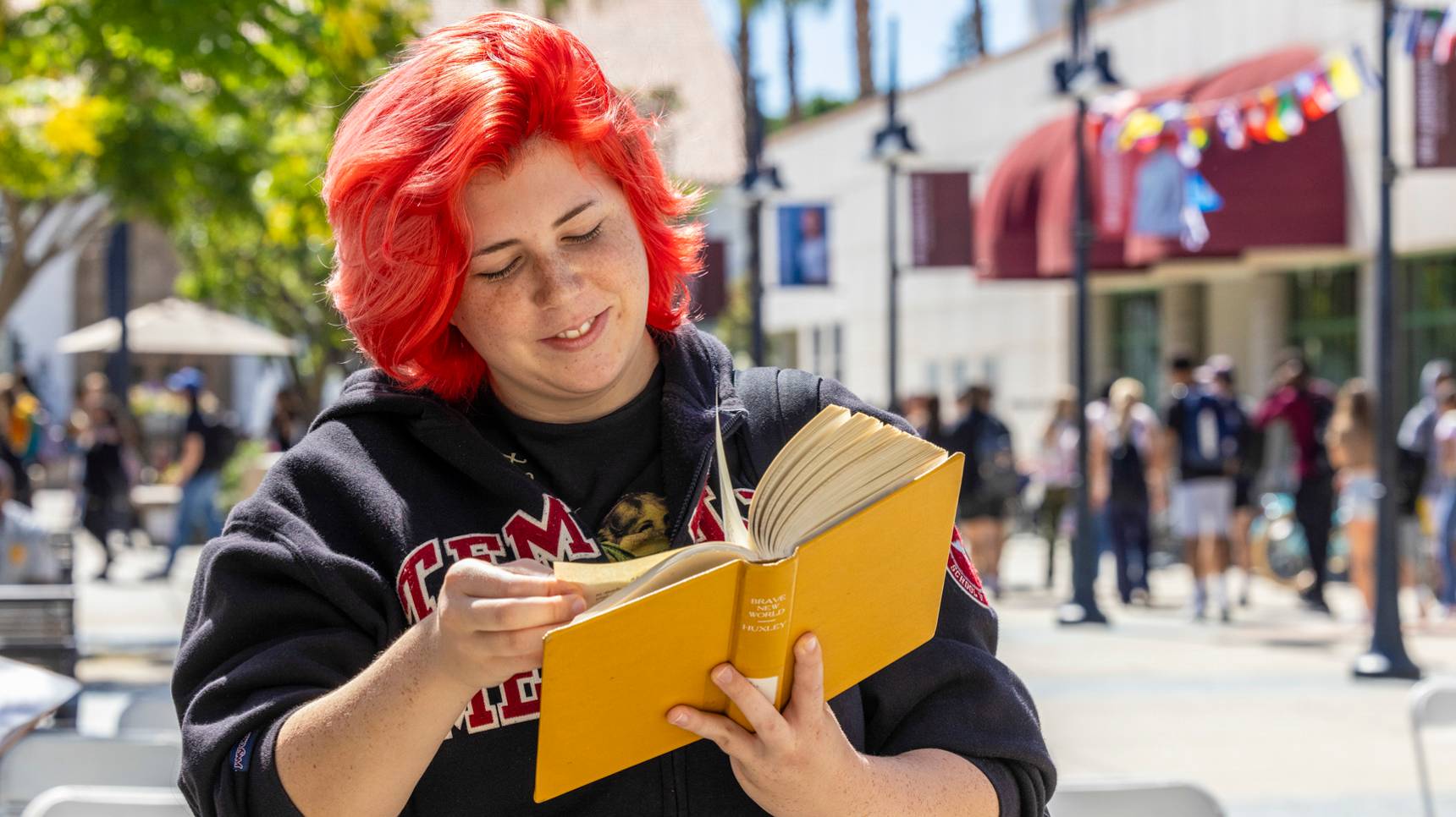 a person with red hair reading a book