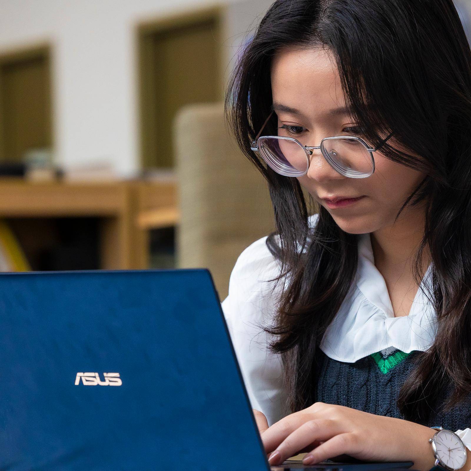 a child looking at a laptop