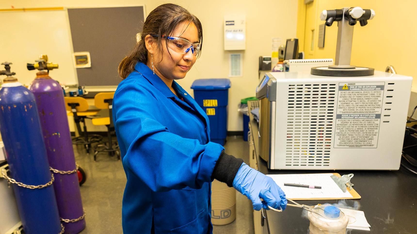 a person wearing blue gloves and blue coat