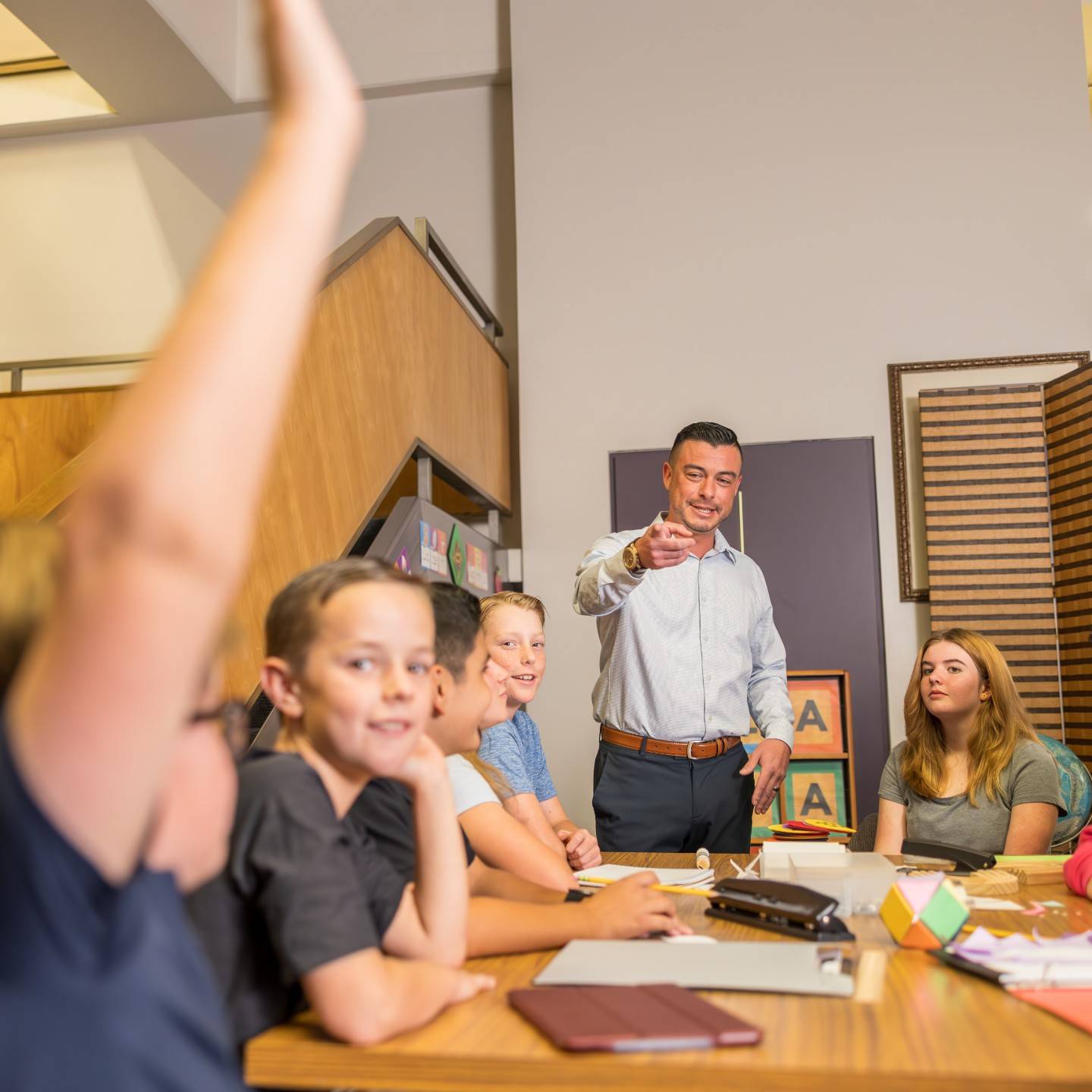 a person standing in front of a group of kids