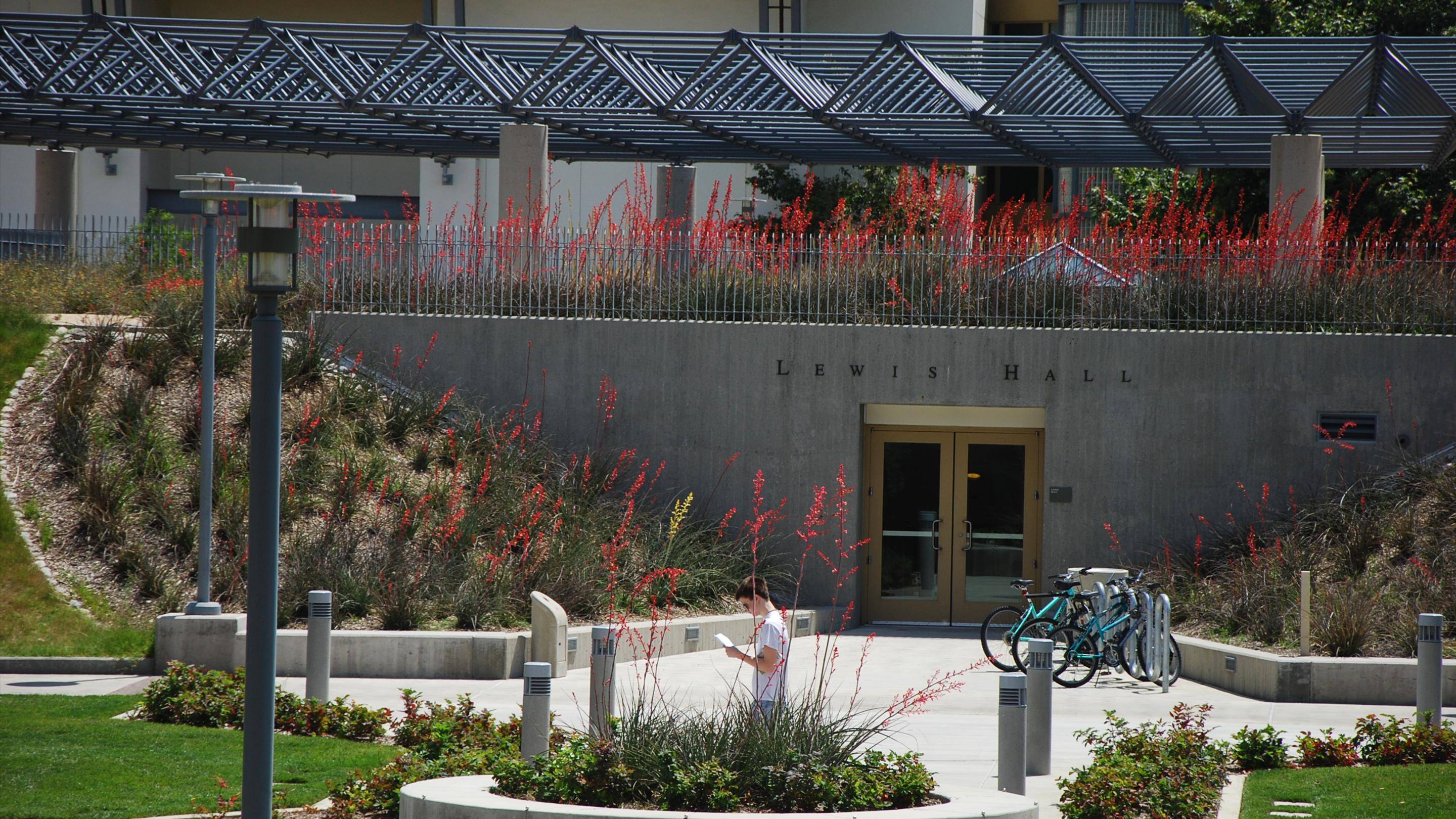 a person reading a book in front of a building