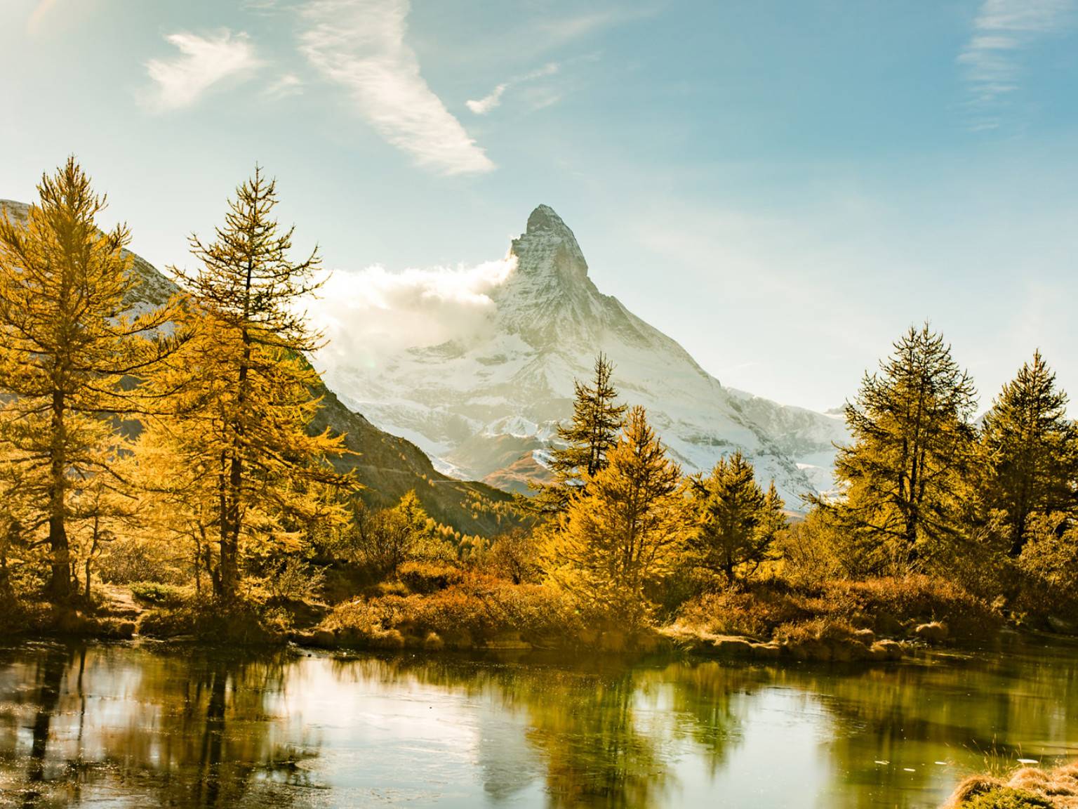 a lake surrounded by trees and mountains