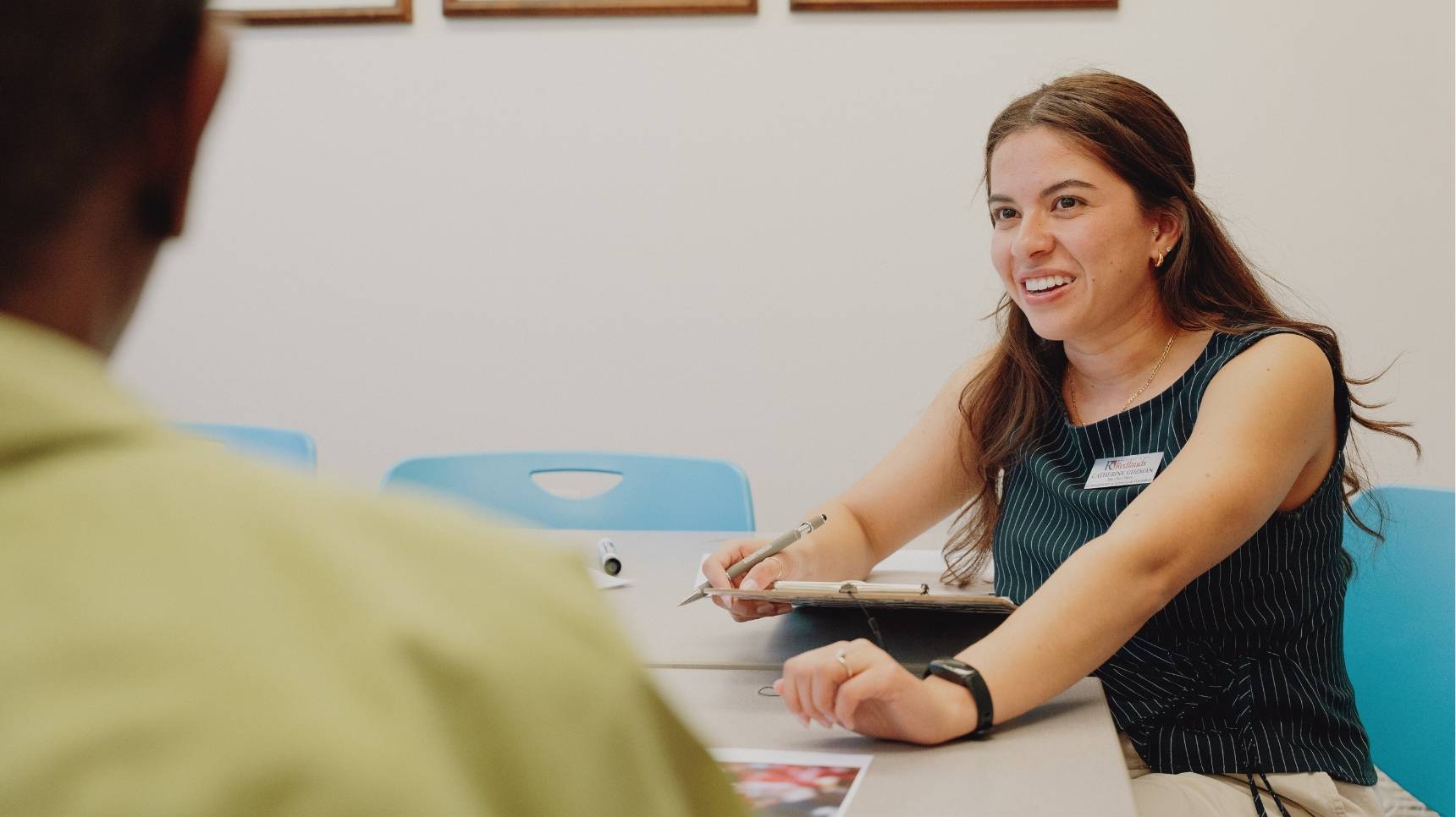 a person sitting at a table smiling