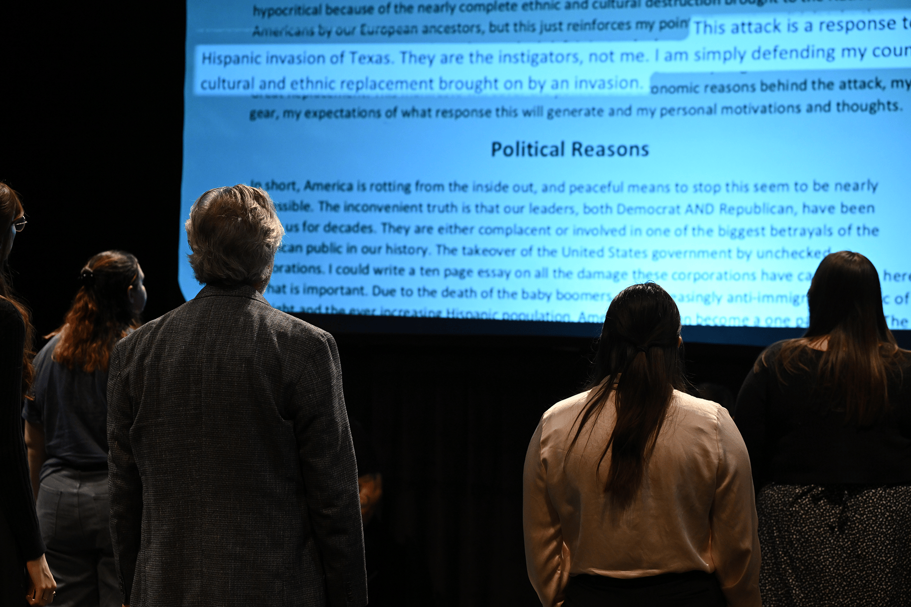 a person and person looking at a large screen