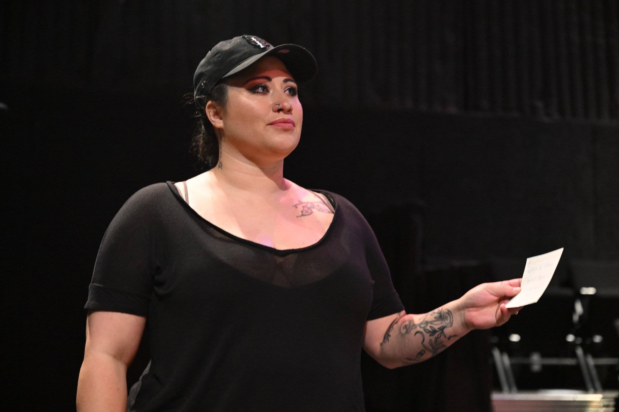 a person wearing a hat and black shirt