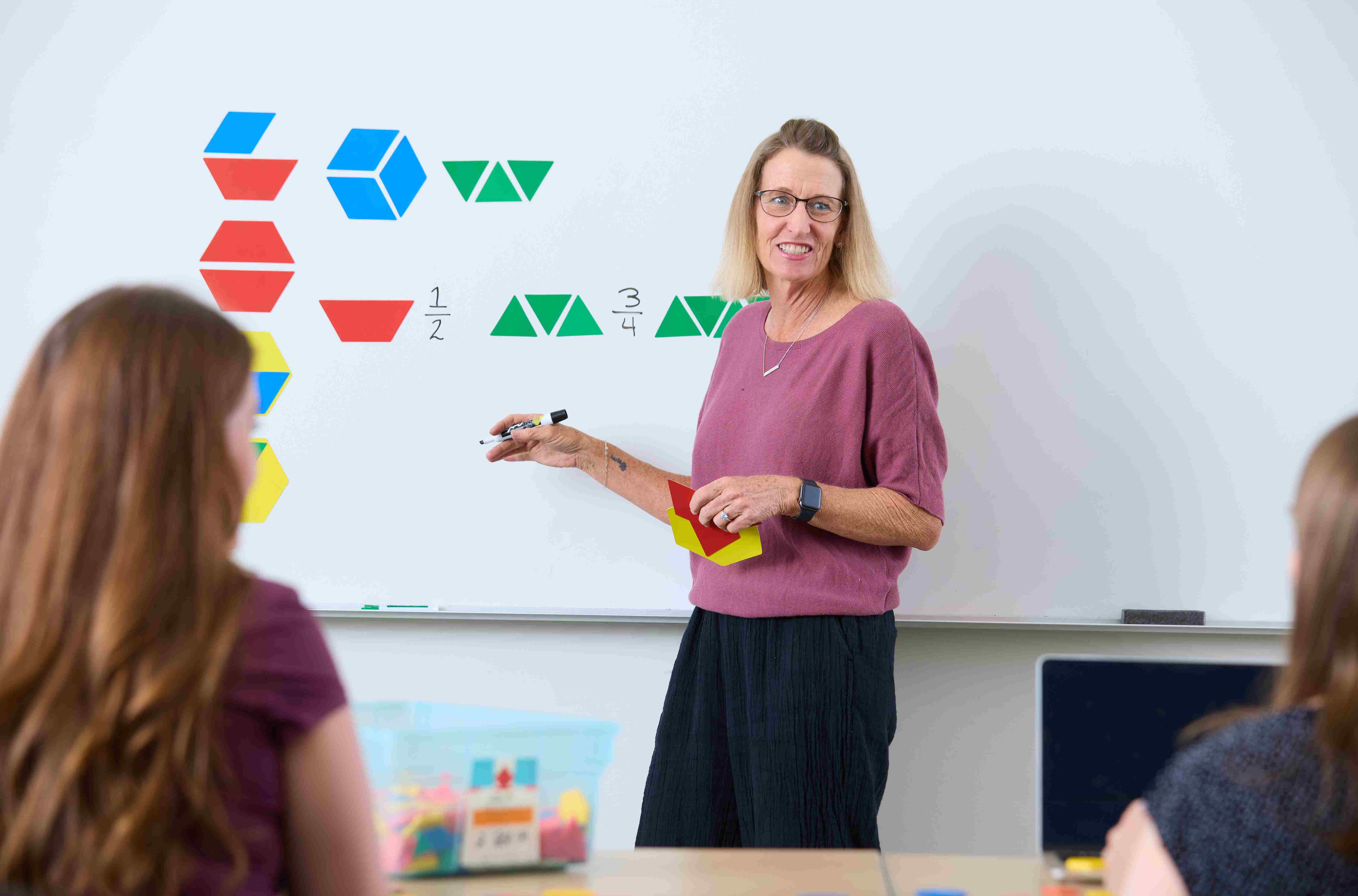 a person standing in front of a whiteboard