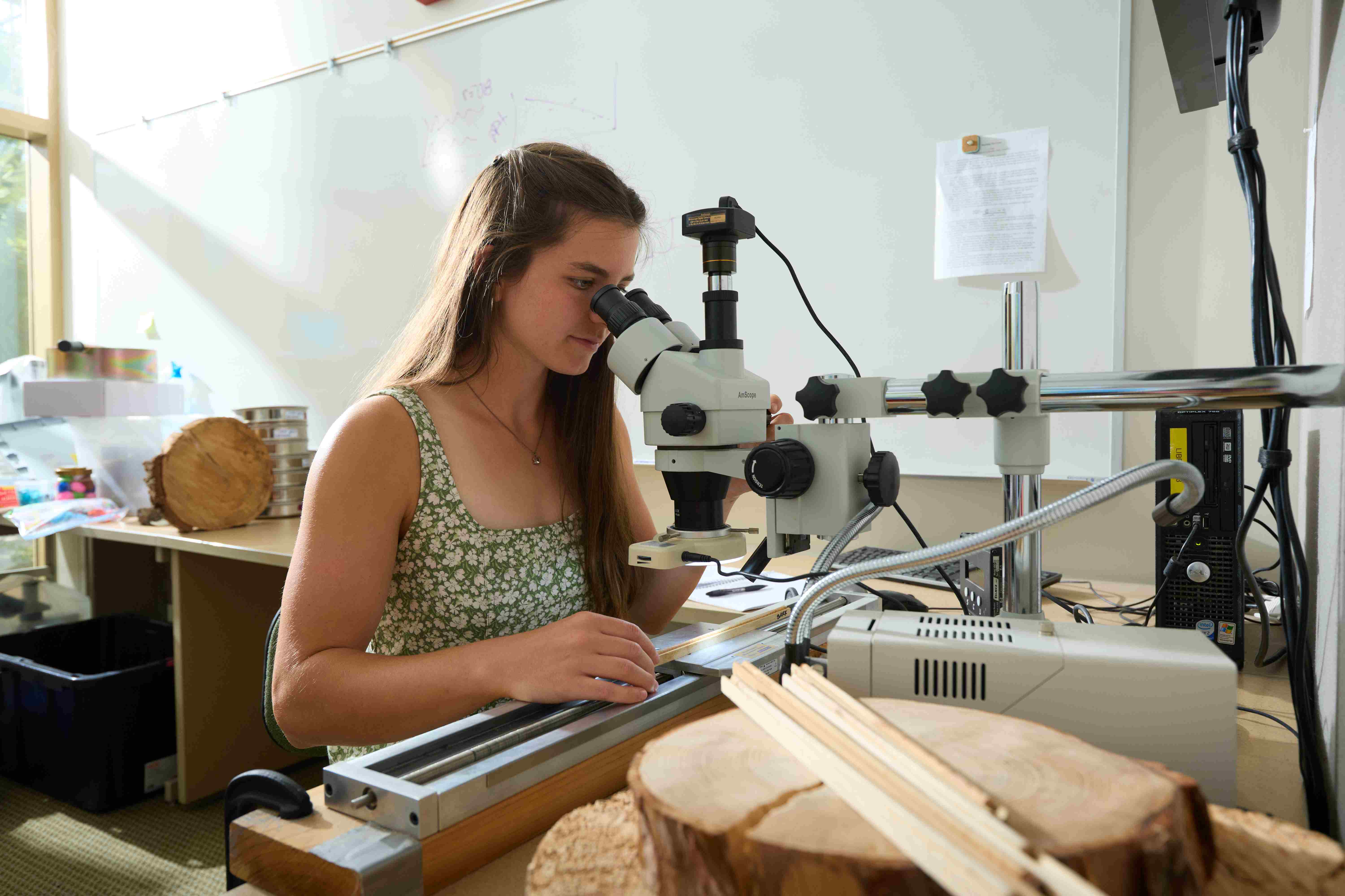 a person looking through a microscope