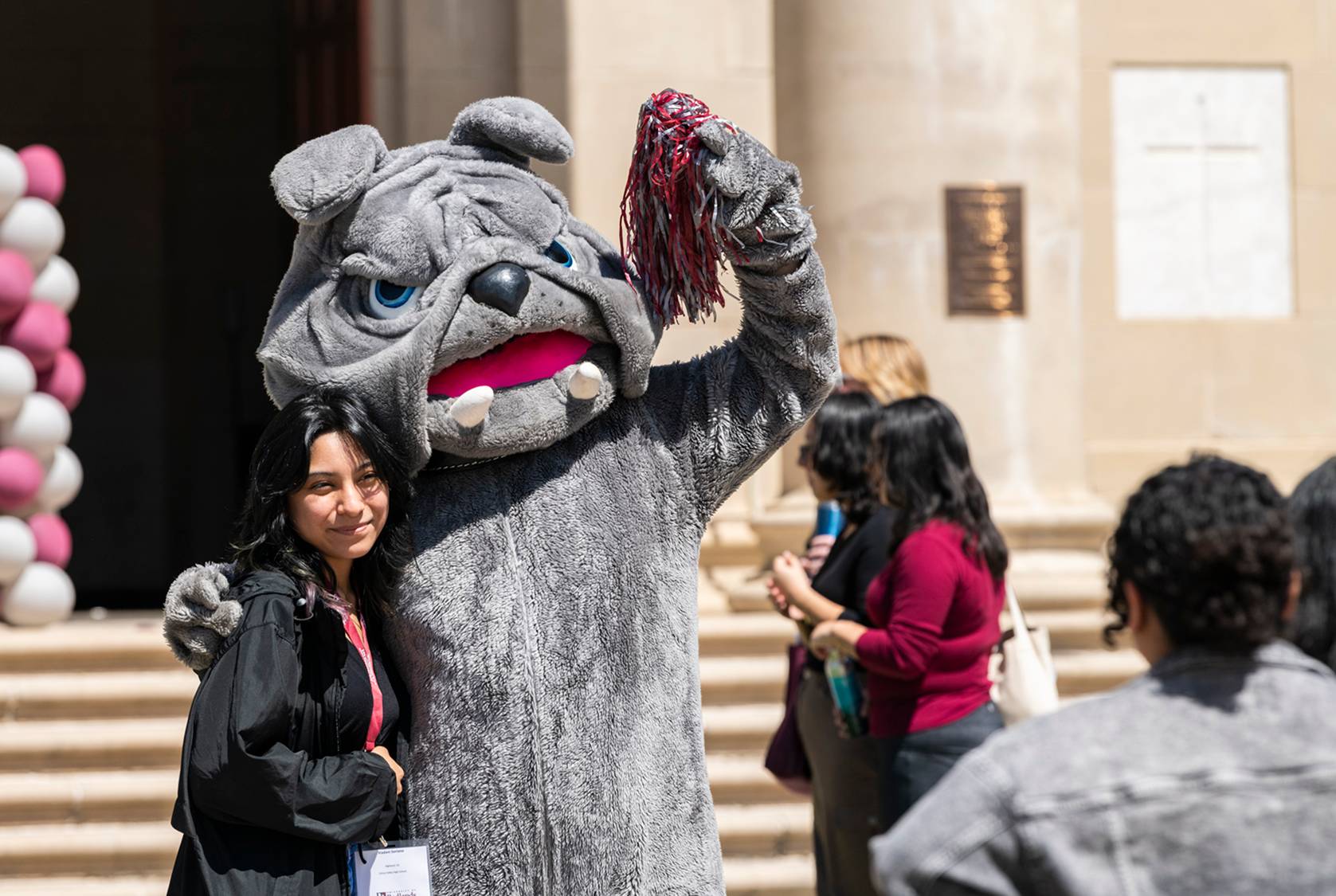 a person in a mascot garment posing with a person
