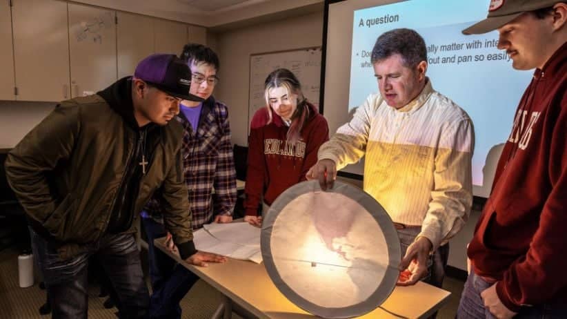 a group of people looking at a paper