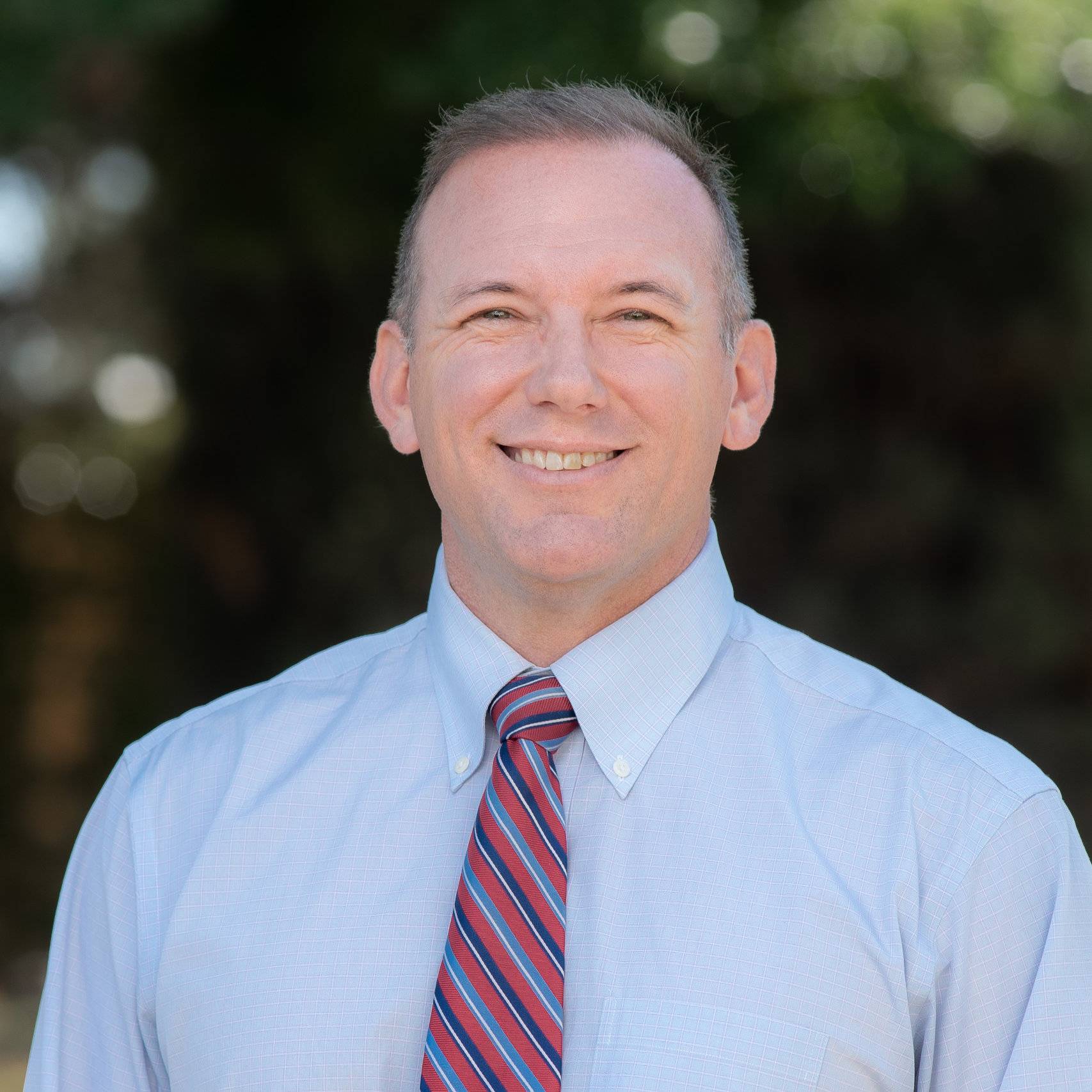 a person wearing a tie and smiling