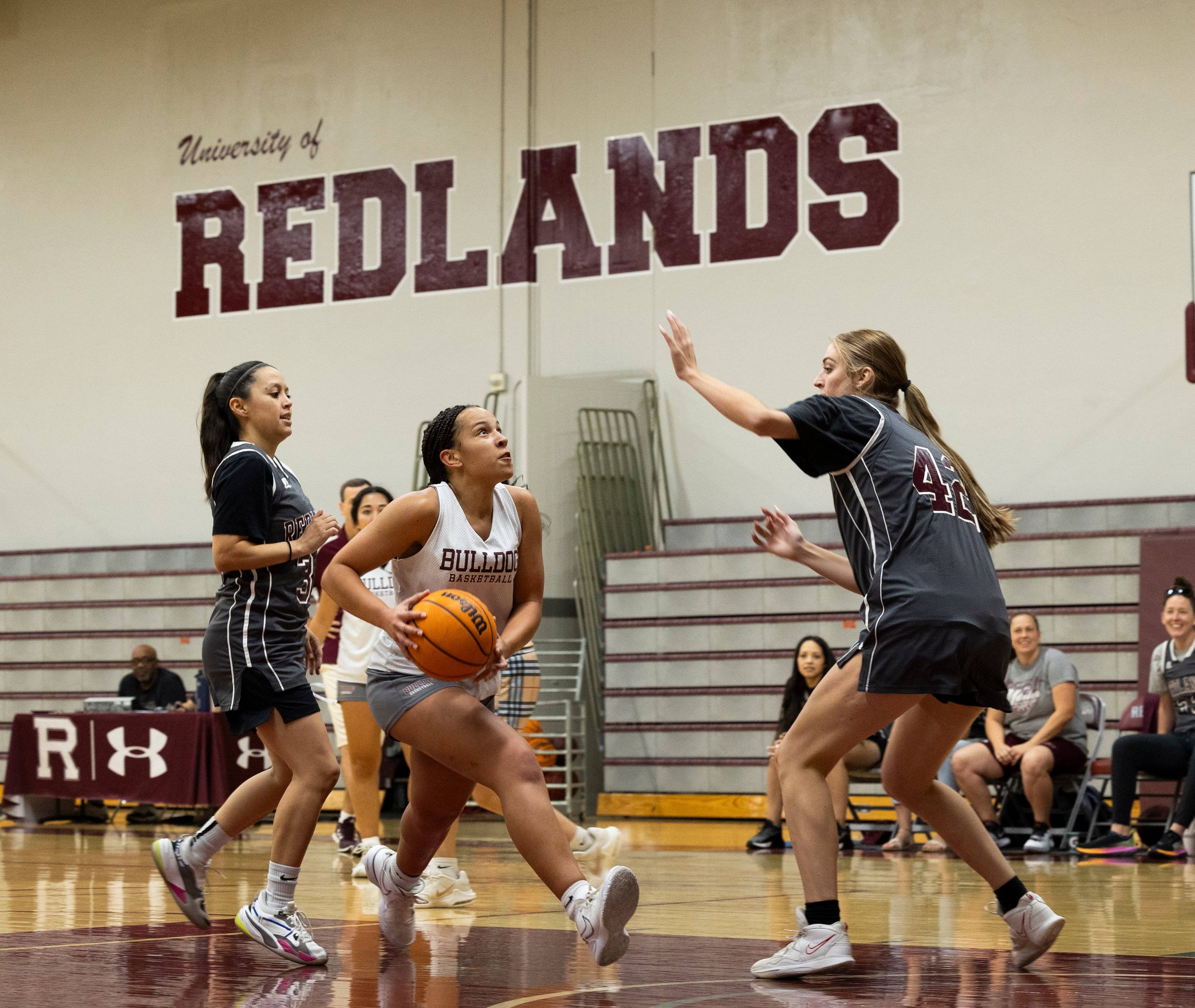 a group of childs playing basketball