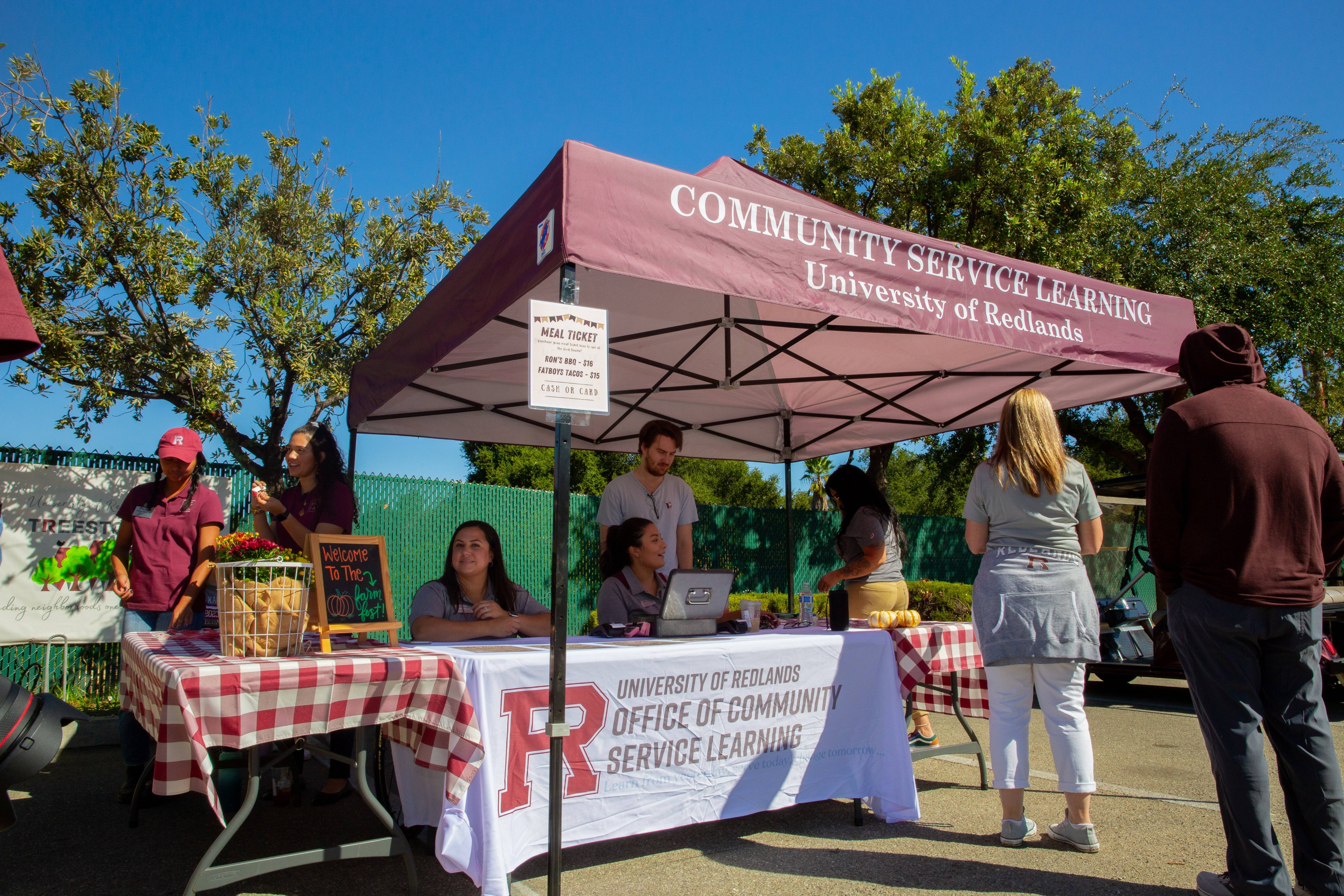 people at a table under a tent