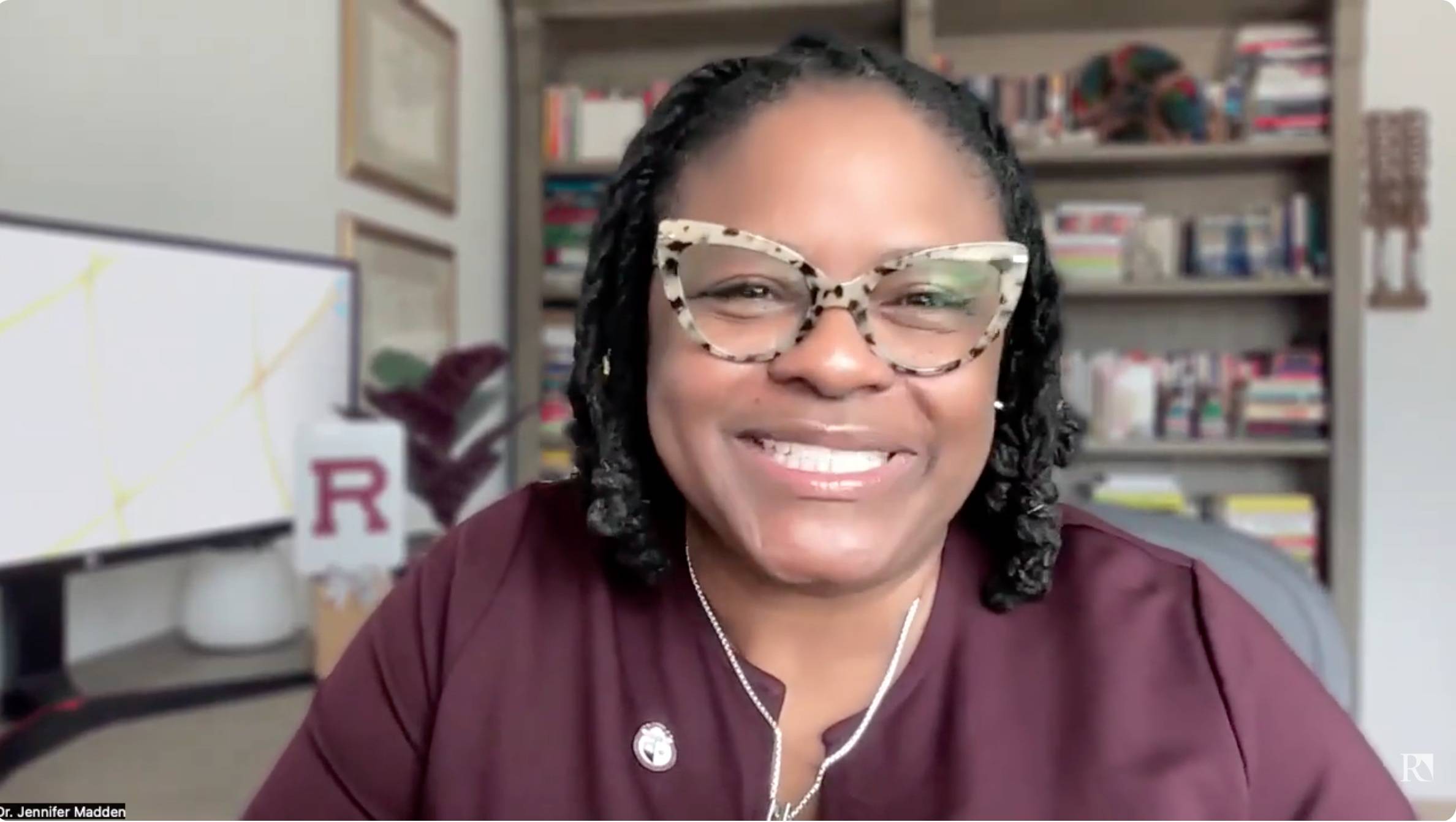 a person wearing glasses smiling